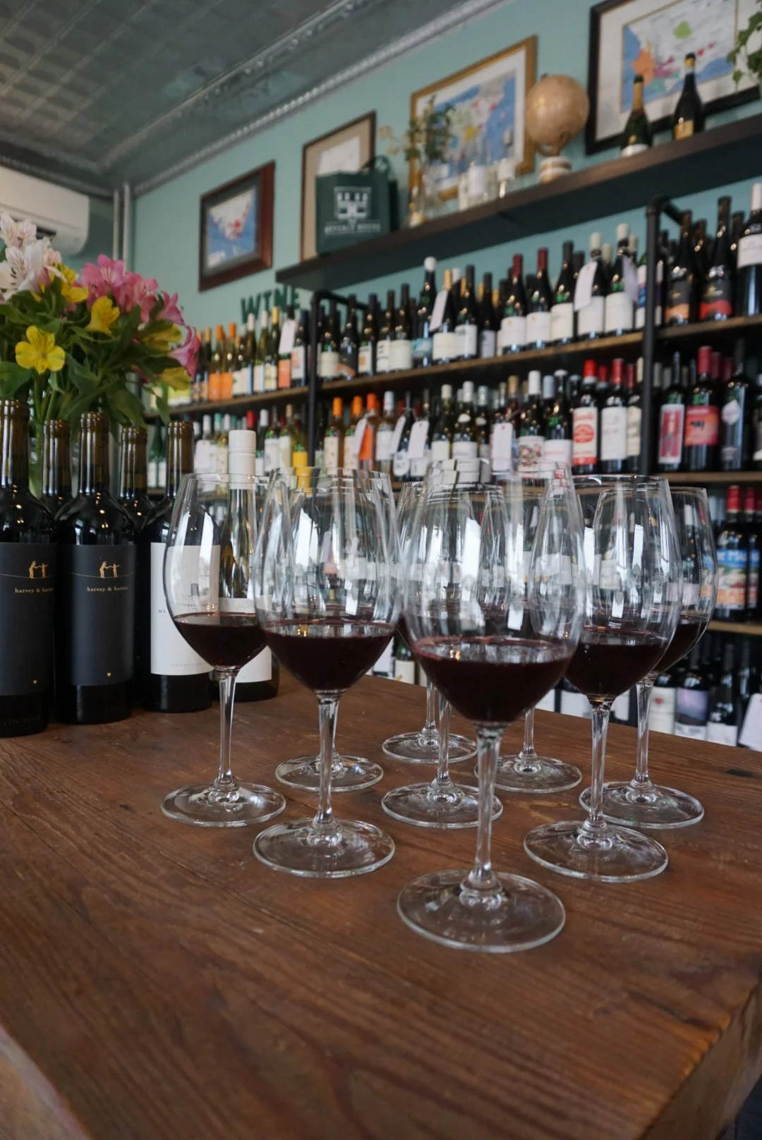 Wine tasting setup with glasses and bottles in a cozy shop