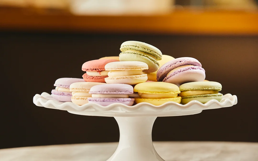 Colorful French macarons on a decorative cake stand