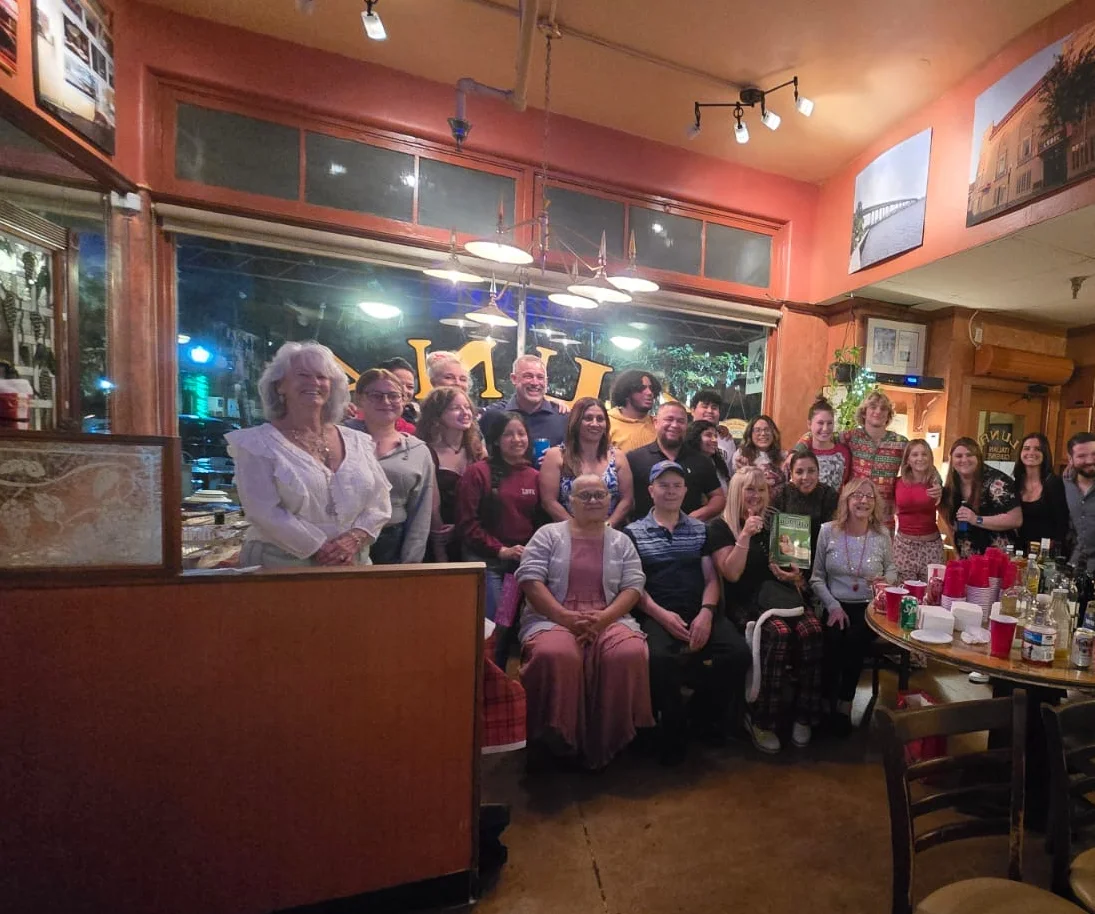 Group gathering in a cozy restaurant setting with festive decor