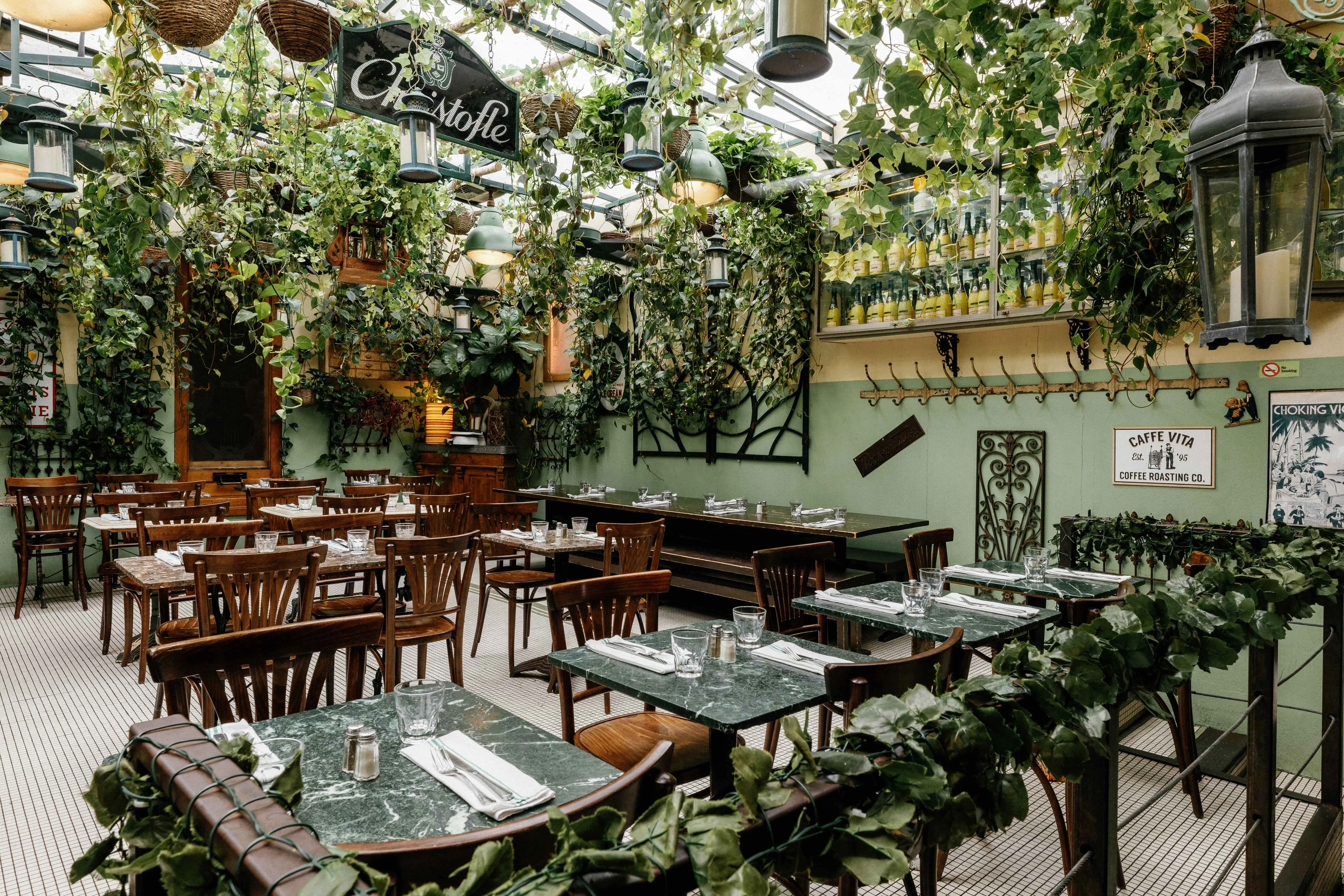 Charming restaurant interior with greenery and wooden furniture