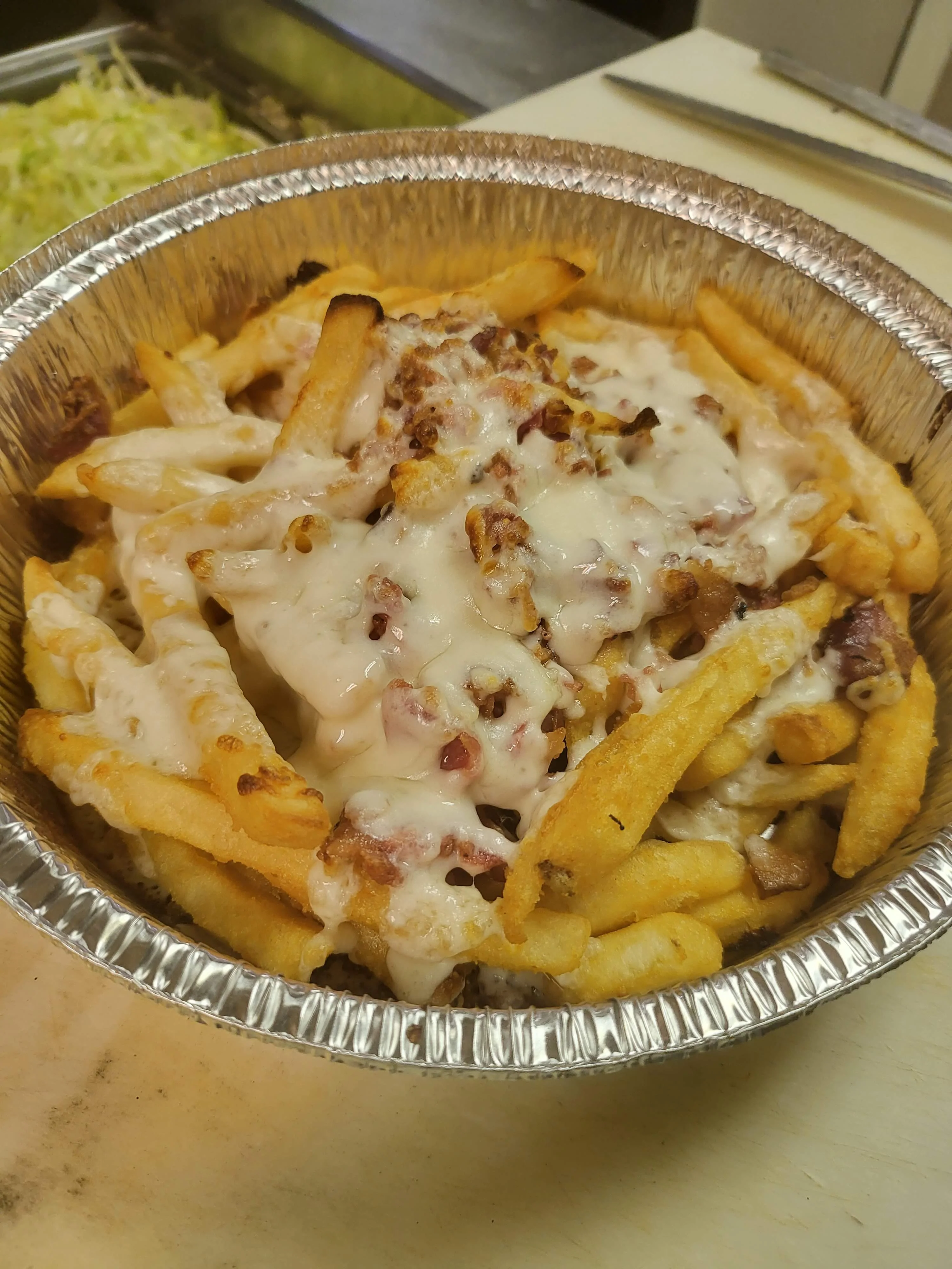 Loaded cheese fries with bacon and creamy sauce