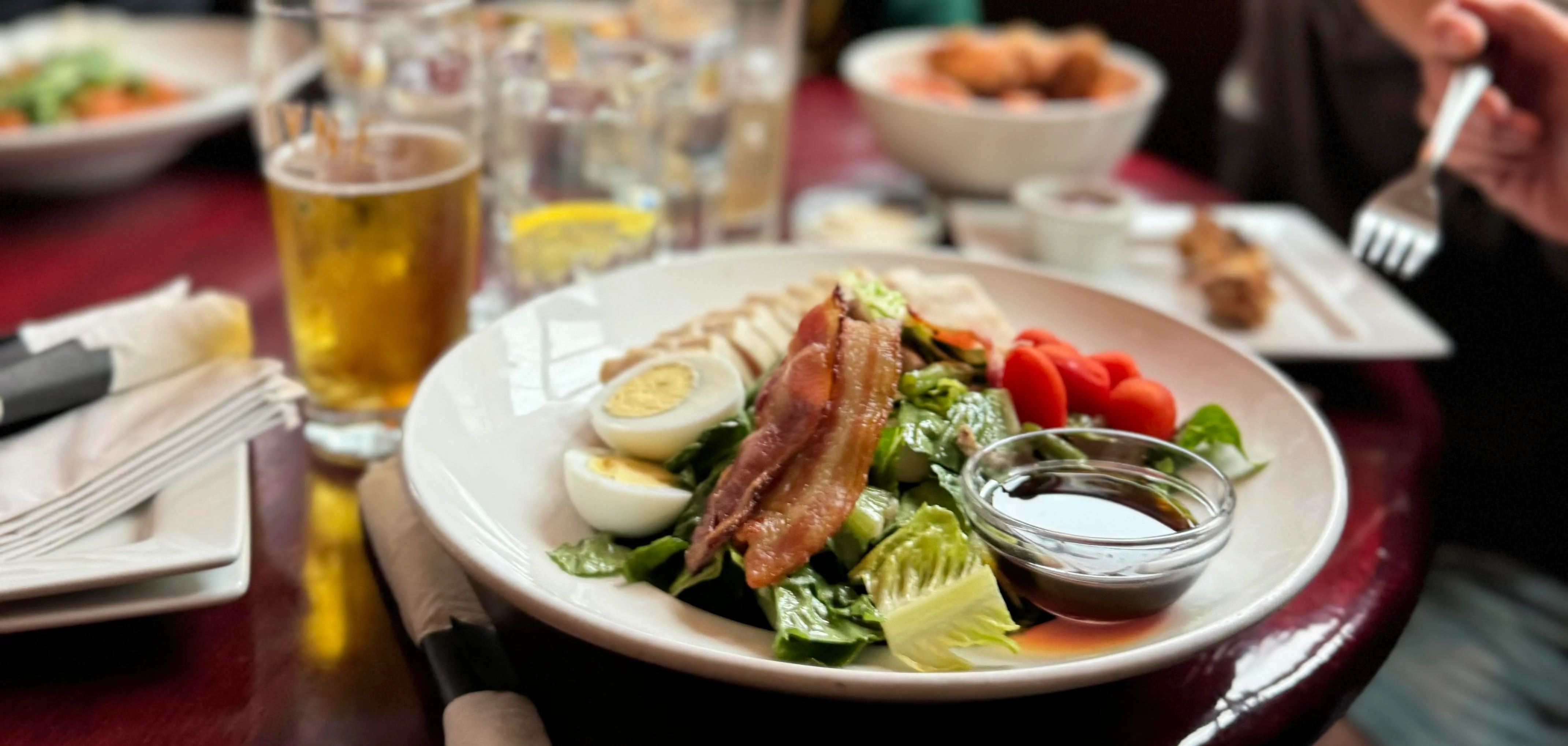Cobb salad with bacon, eggs, and cherry tomatoes