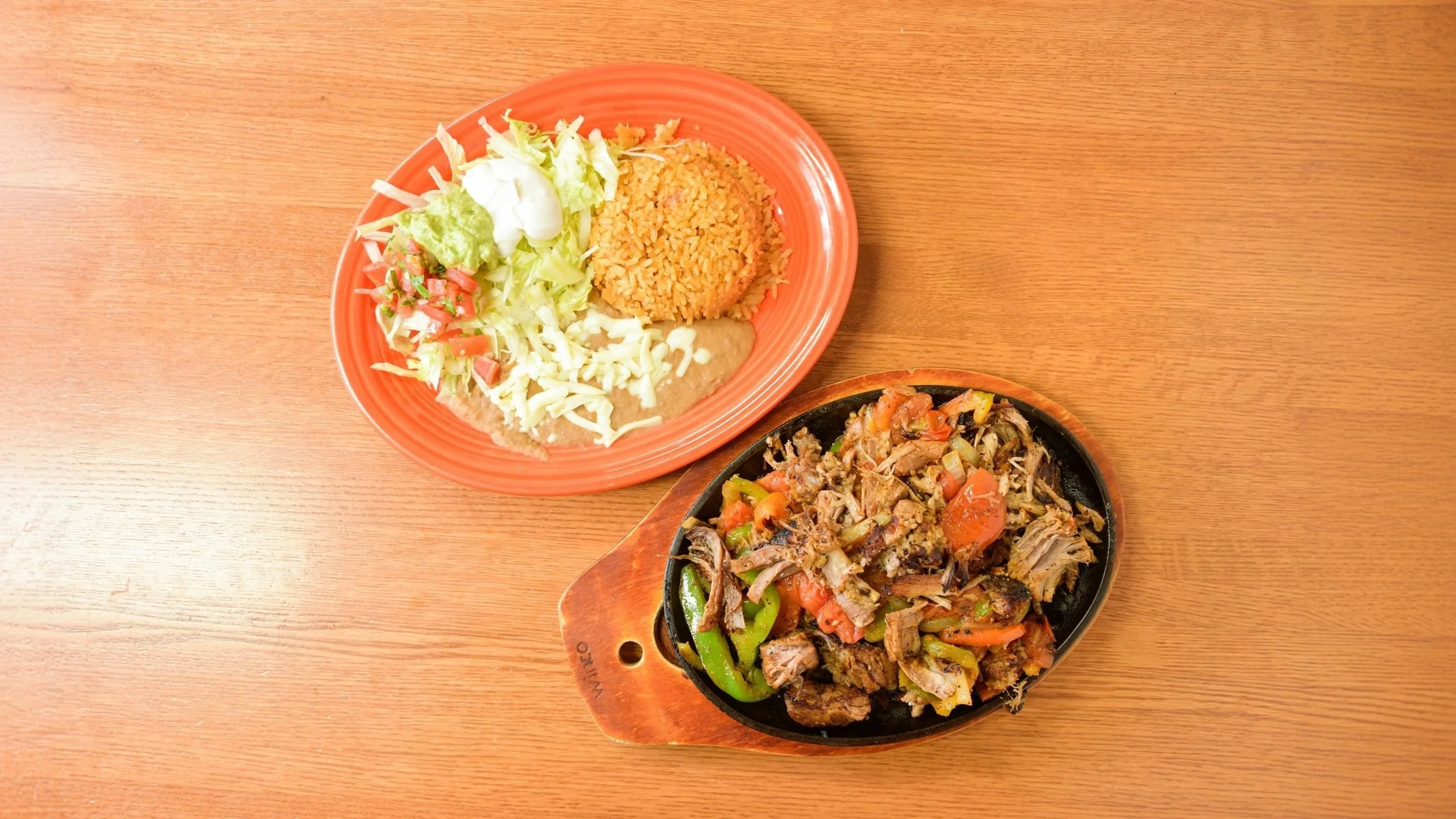 Sizzling fajitas served with rice and salad in a vibrant Mexican restaurant