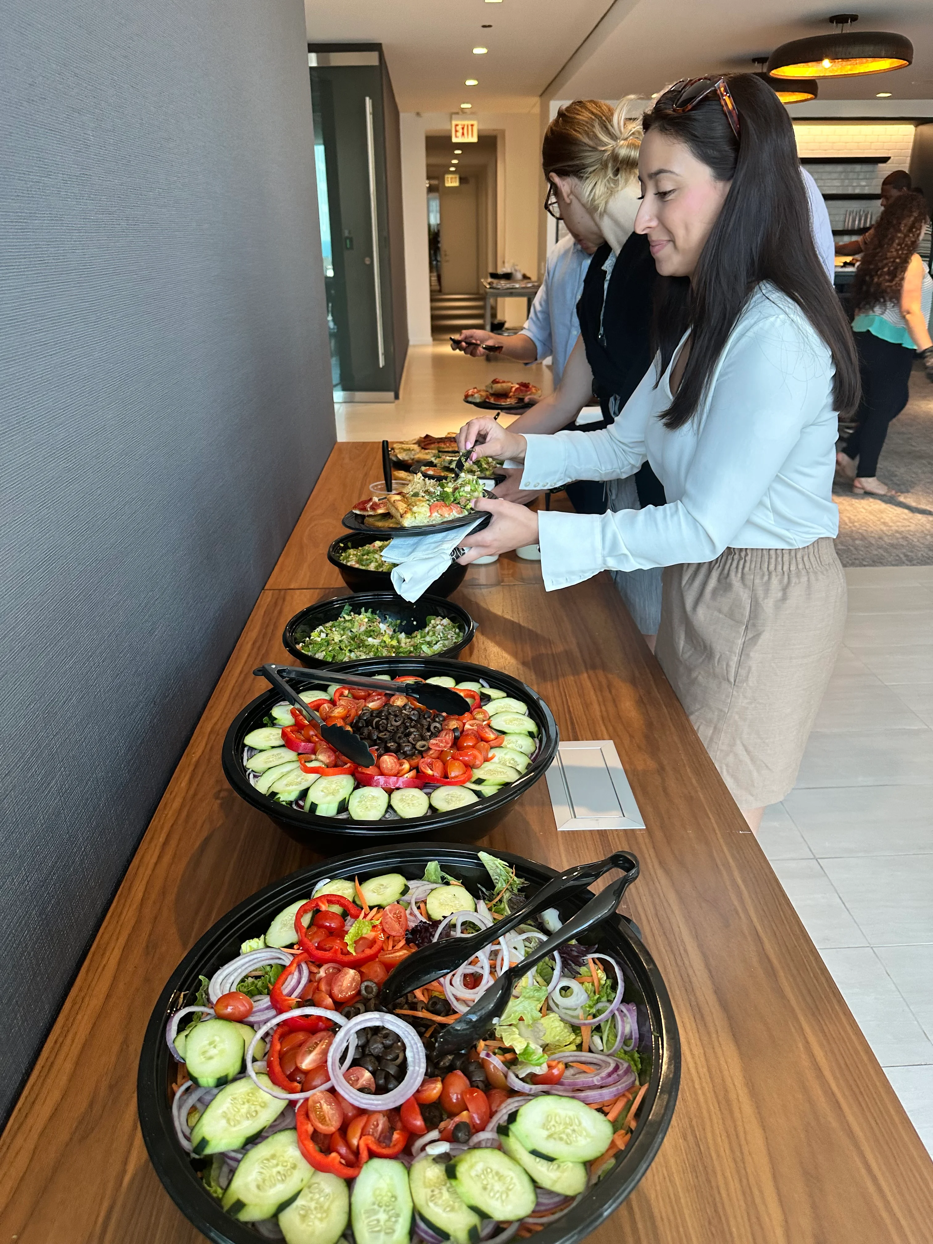 A table with a catering spread of food