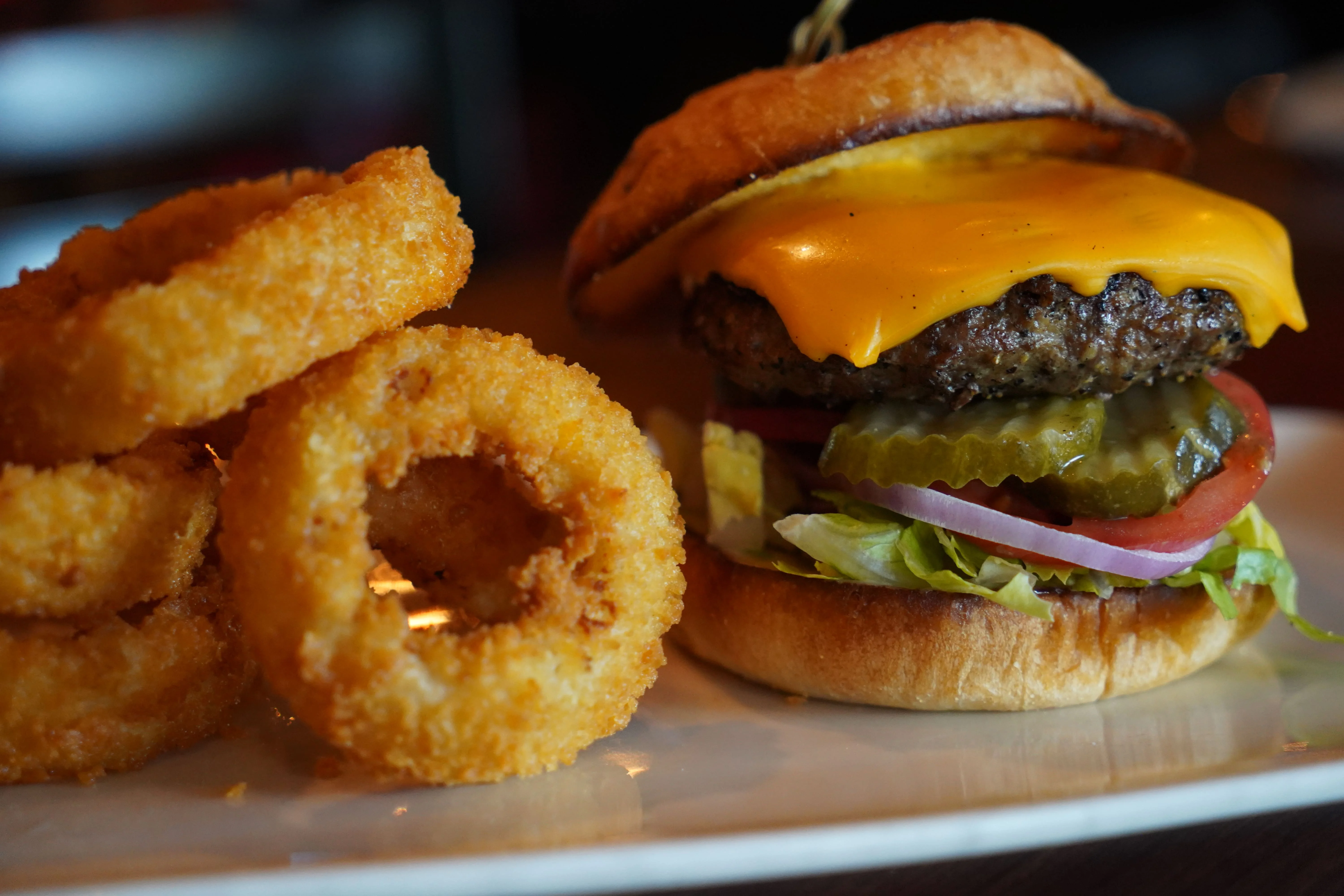 Classic American cheeseburger with onion rings