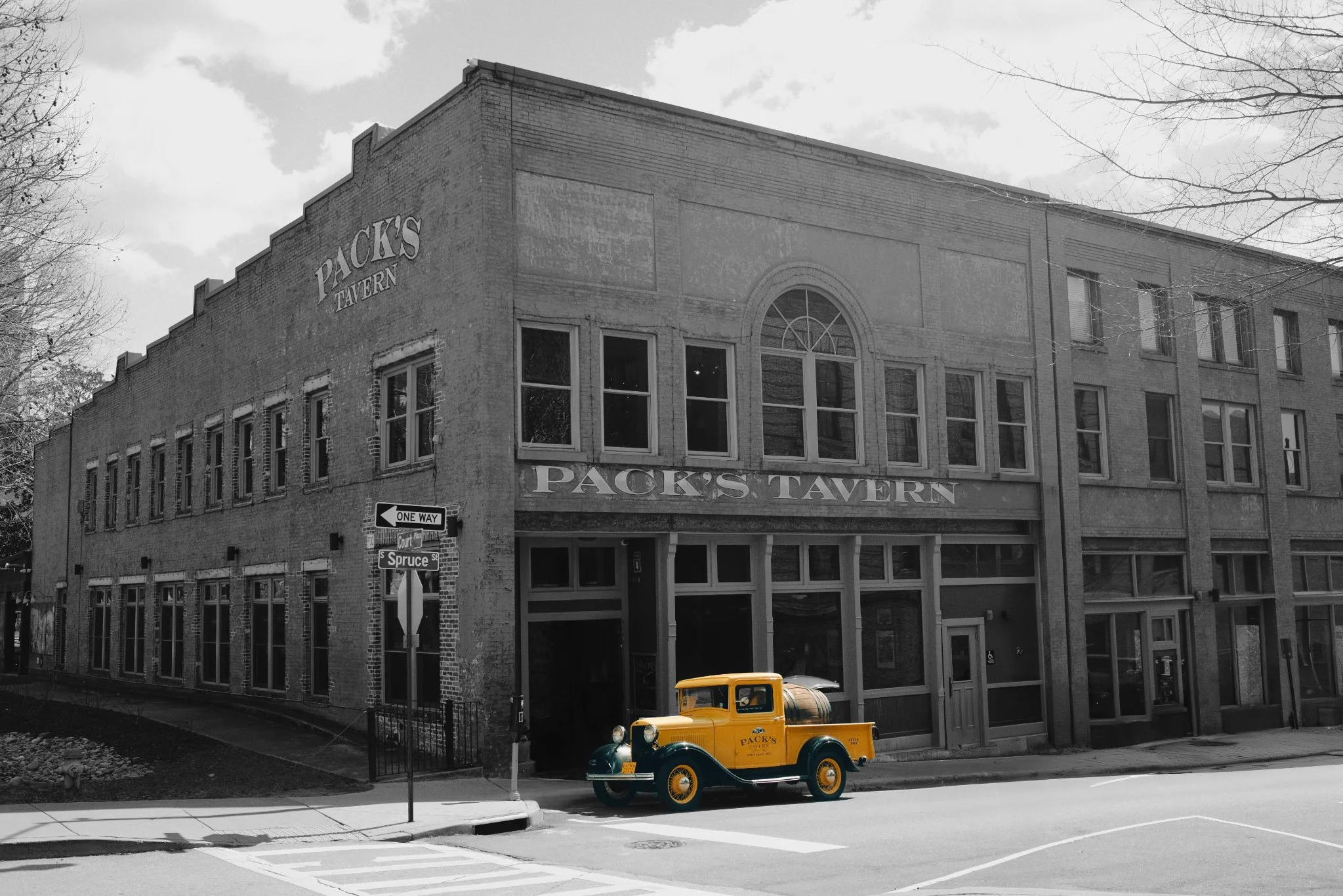 Historic tavern exterior with vintage yellow truck