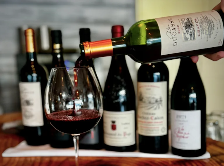 Pouring red wine into a glass at a restaurant