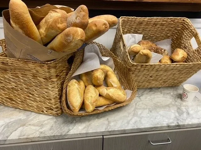Assorted French bread loaves in woven baskets