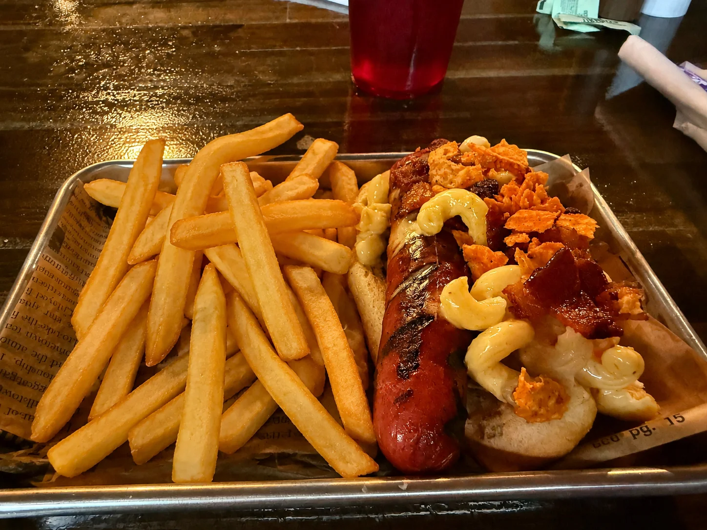 Loaded hot dog with mac and cheese, bacon, and fries