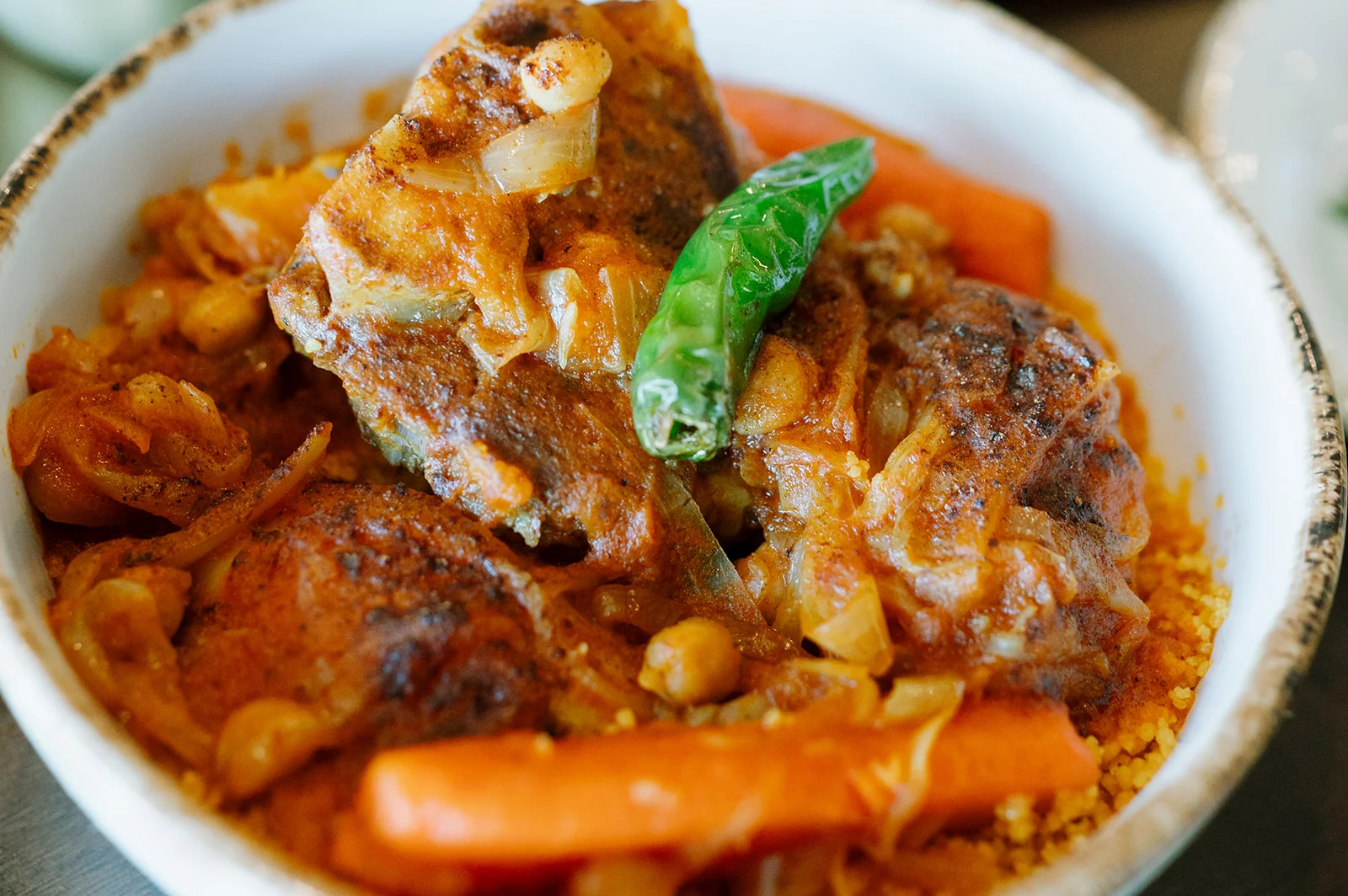 Libyan couscous with tomato stew, vegetables and a Serrano pepper at Tripoli's in Alamo Ranch, San Antonio