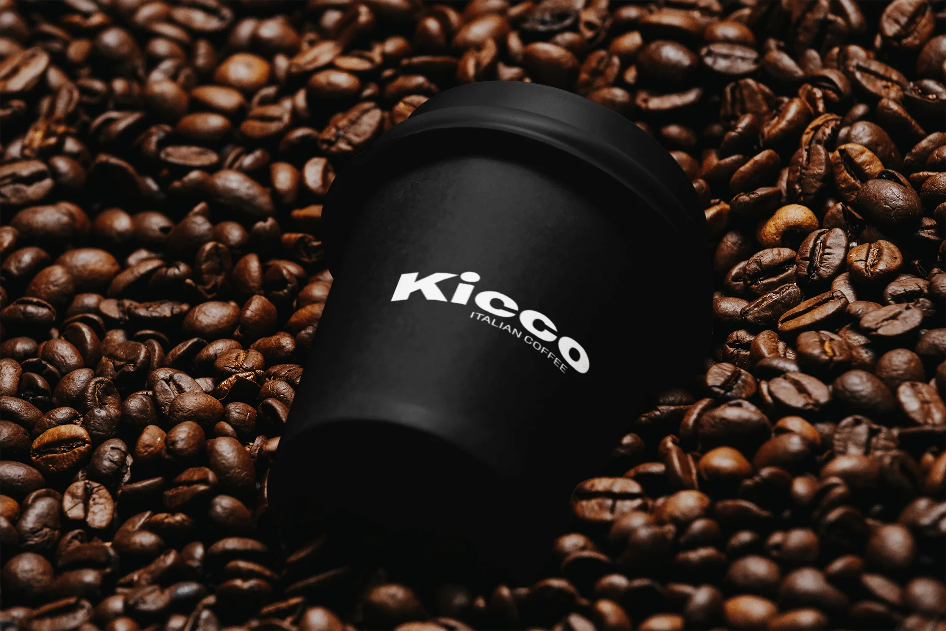 Black coffee cup on roasted coffee beans