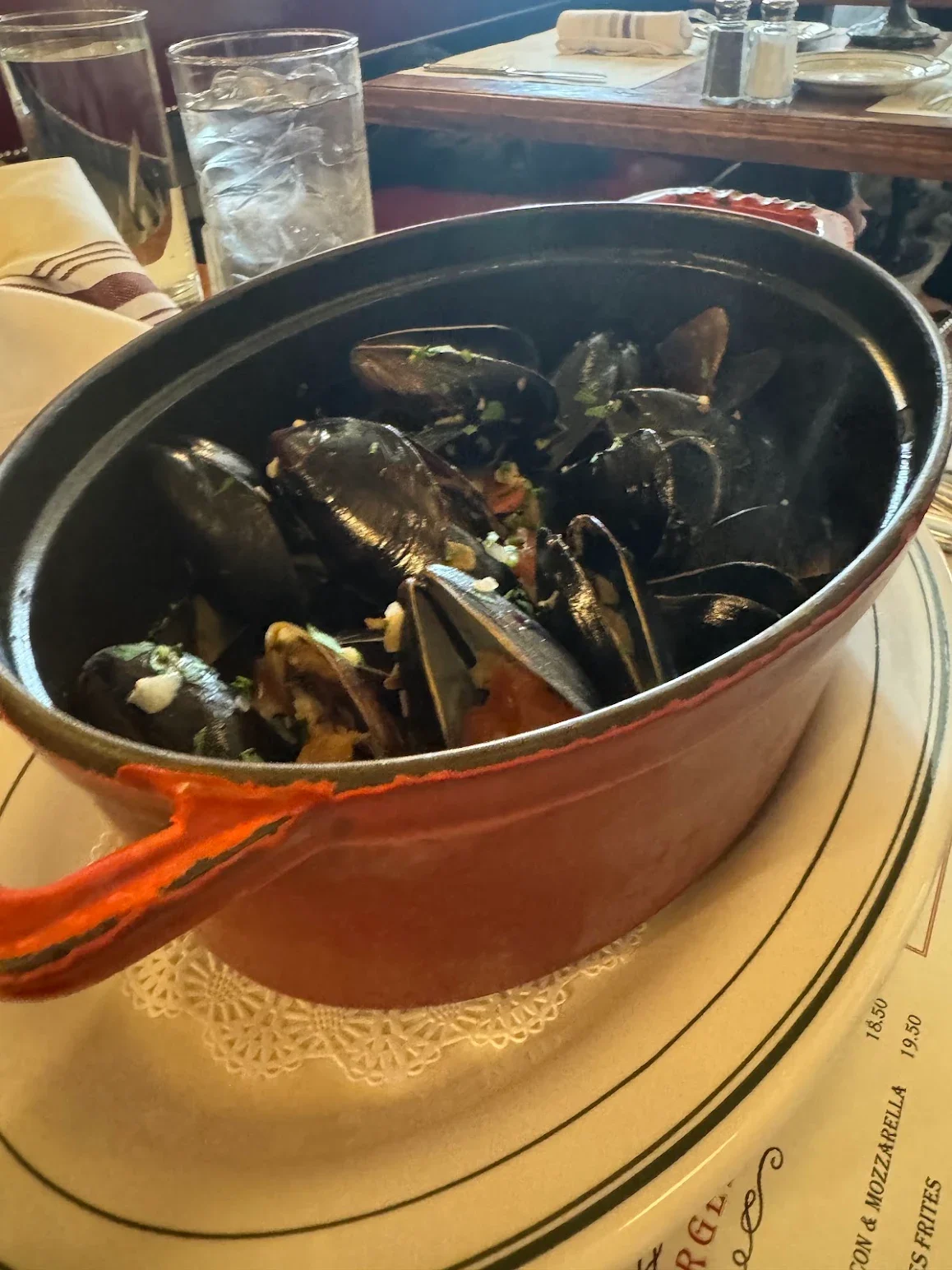 Steaming pot of mussels in a rich broth