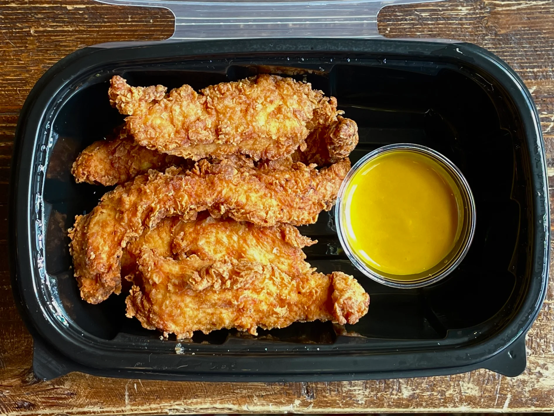 Crispy Southern fried chicken tenders with honey mustard dipping sauce