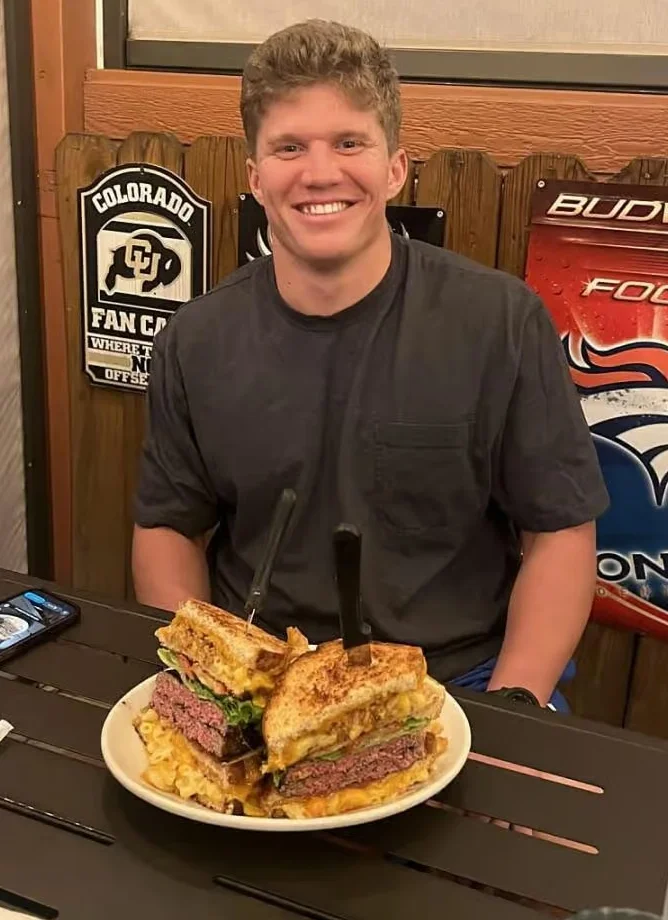 Giant cheeseburger sandwich with fries in a casual dining setting