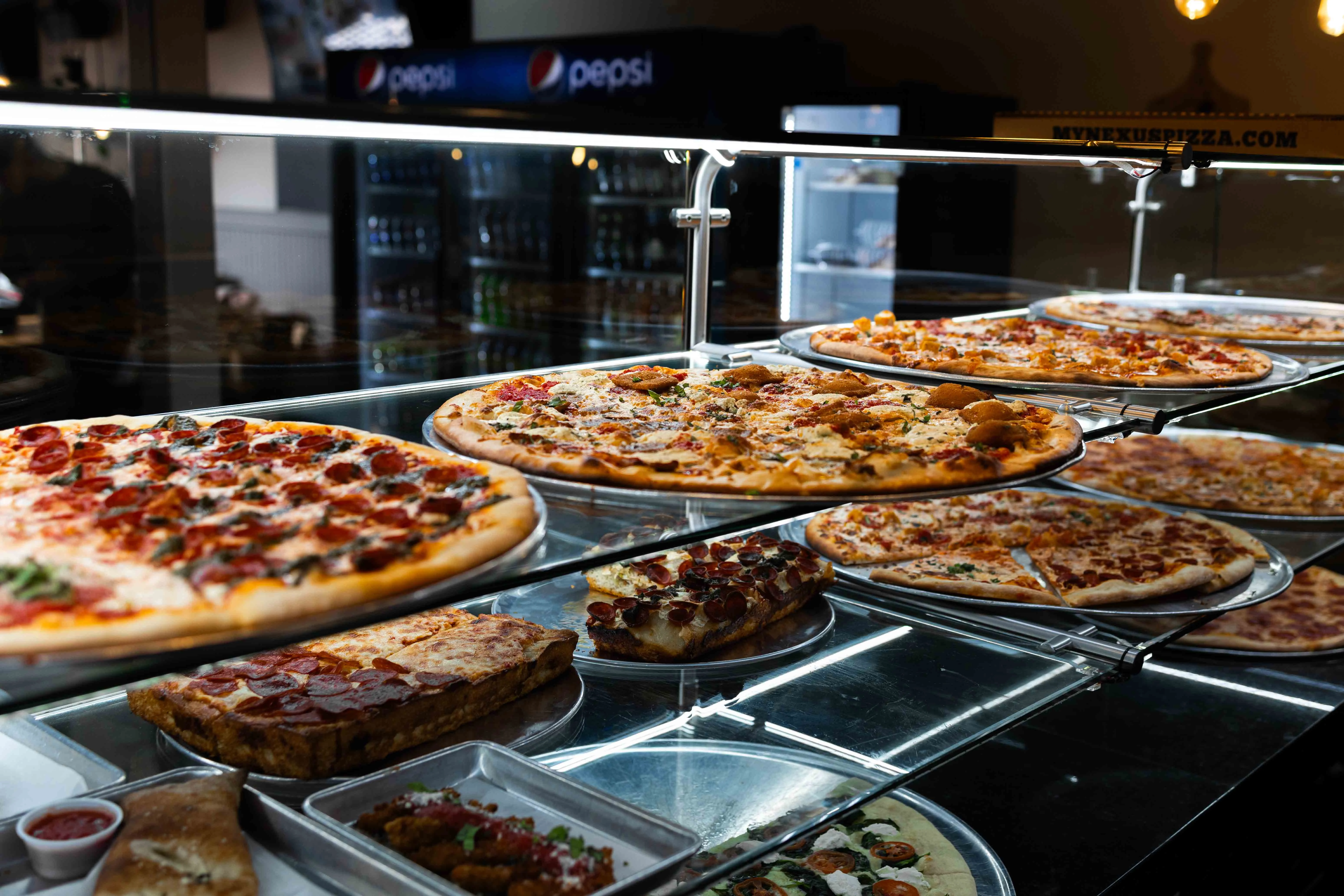 Variety of pizzas displayed in a restaurant