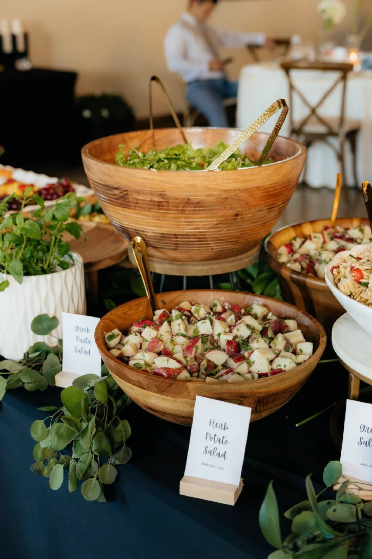 Colorful Mediterranean salad bar with fresh ingredients in wooden bowls