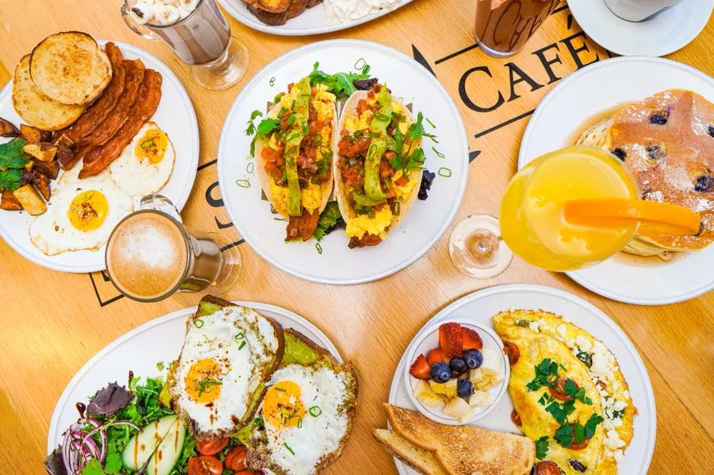 A variety of breakfast dishes including tacos, eggs, and pancakes.