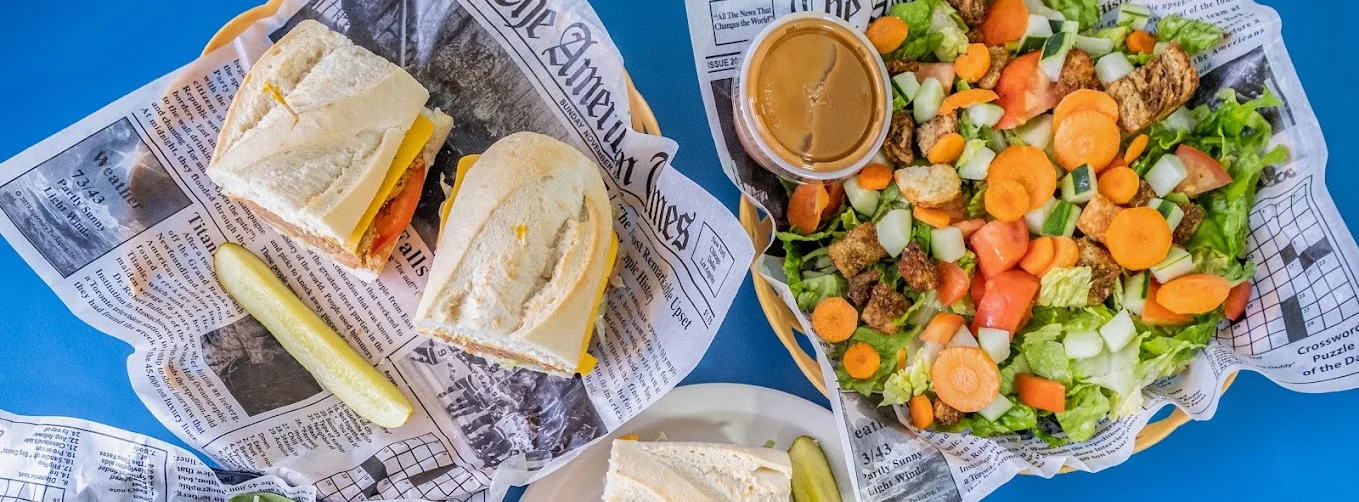 Assorted sandwiches and fresh salad in a casual dining setting