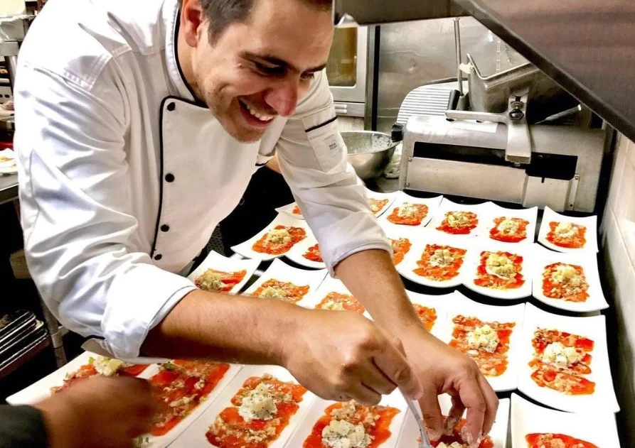 A restaurant chef preparing a dish