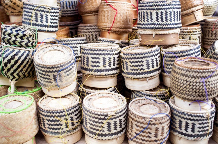 Colorful woven baskets stacked in a market