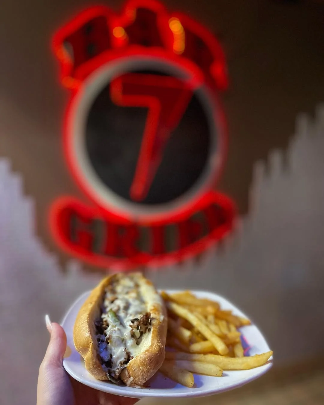 Interior of Bar 7 featuring a Philly cheesesteak dish.