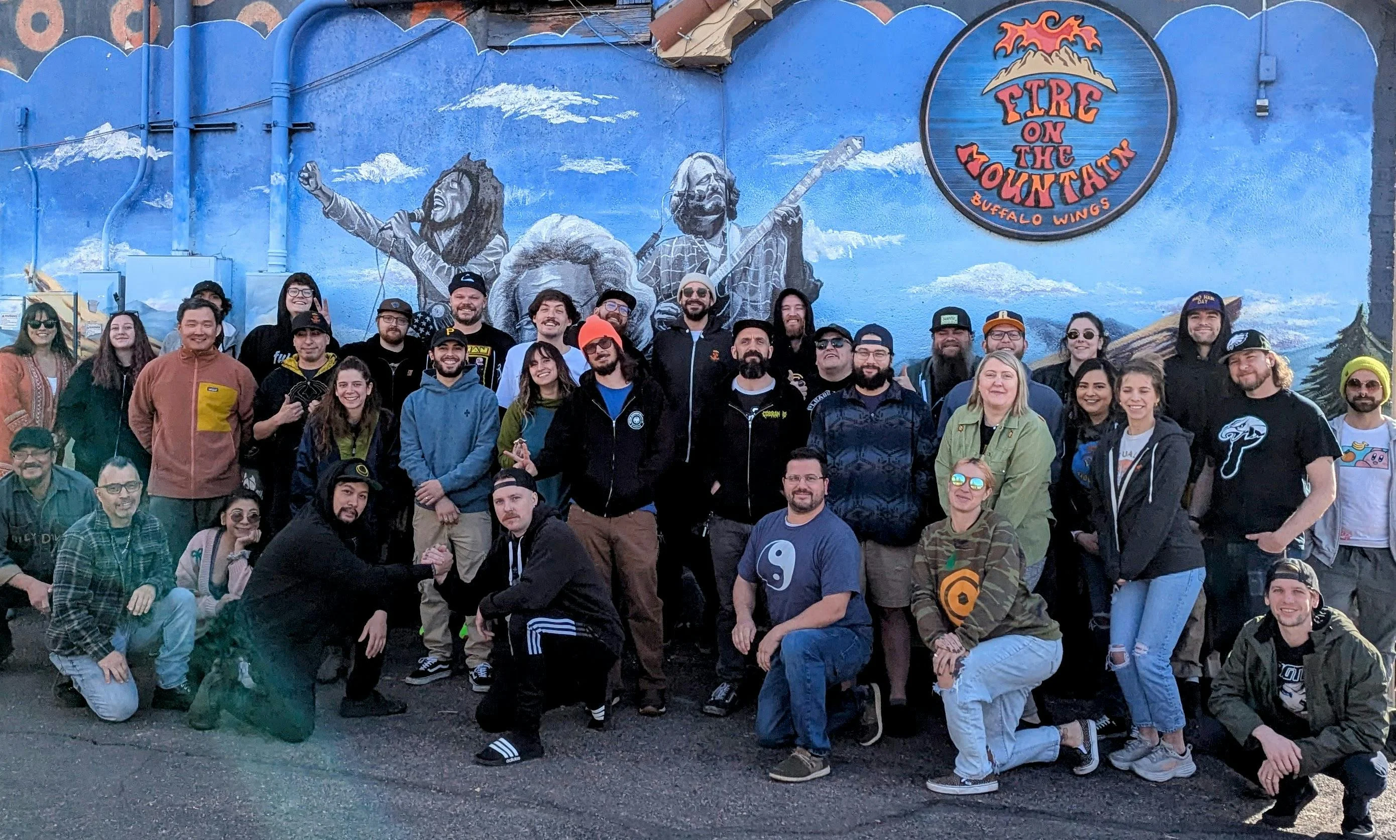 Group photo in front of Fire on the Mountain mural