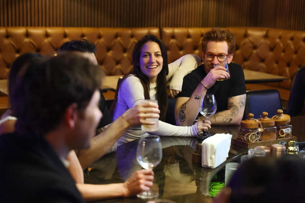 Group of friends enjoying drinks at a stylish bar