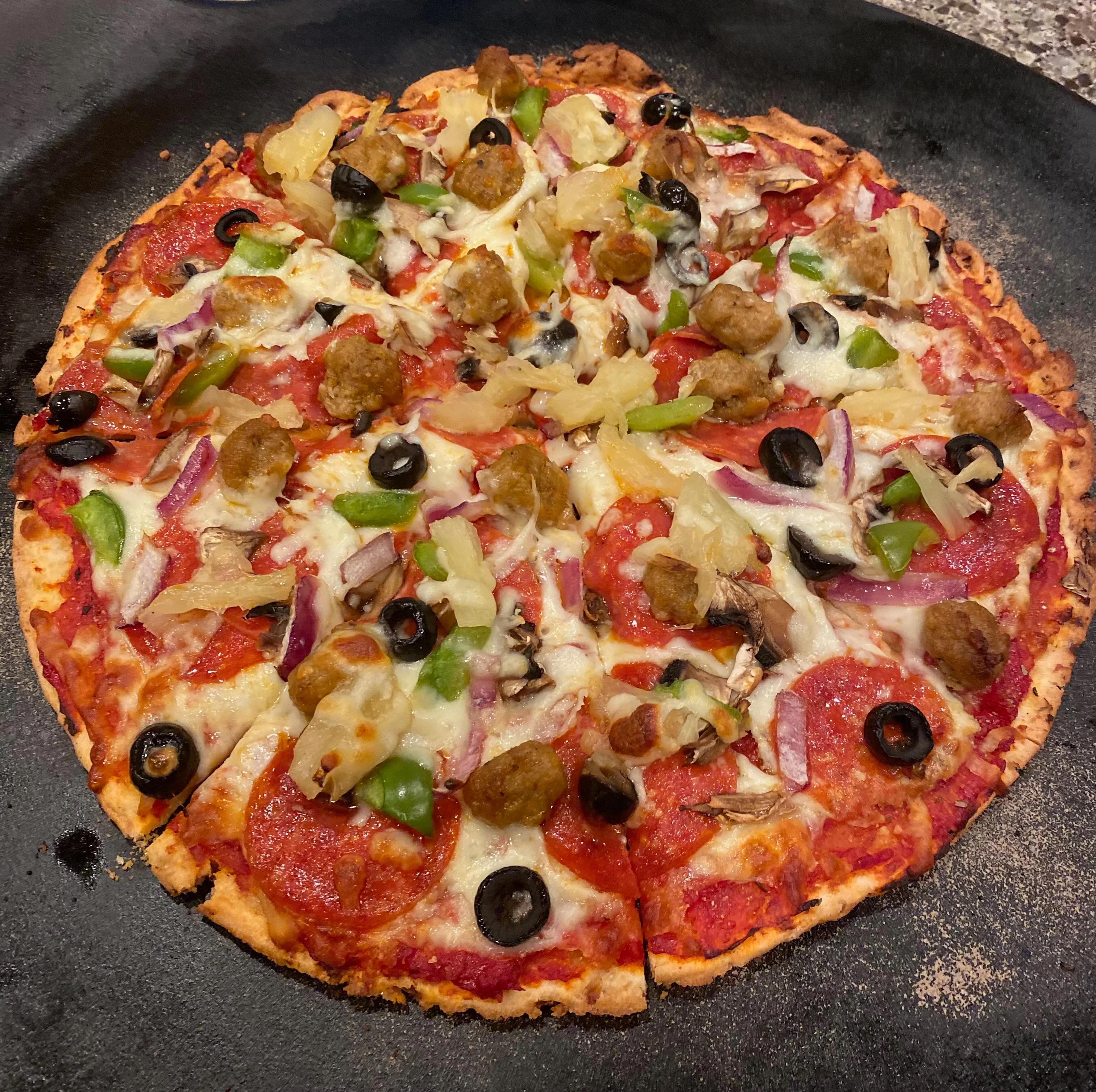 Loaded meat lover's pizza with pepperoni and vegetables