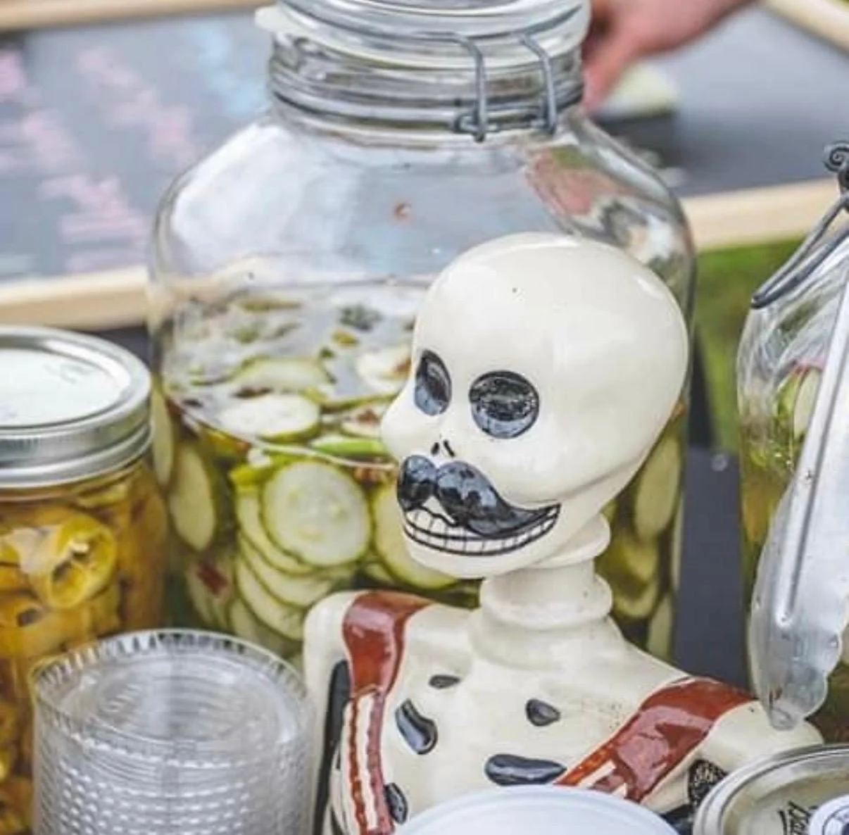 Decorative skeleton with pickled vegetables in jars