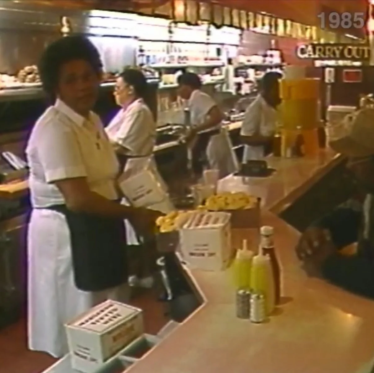 Vintage restaurant counter with staff serving guests