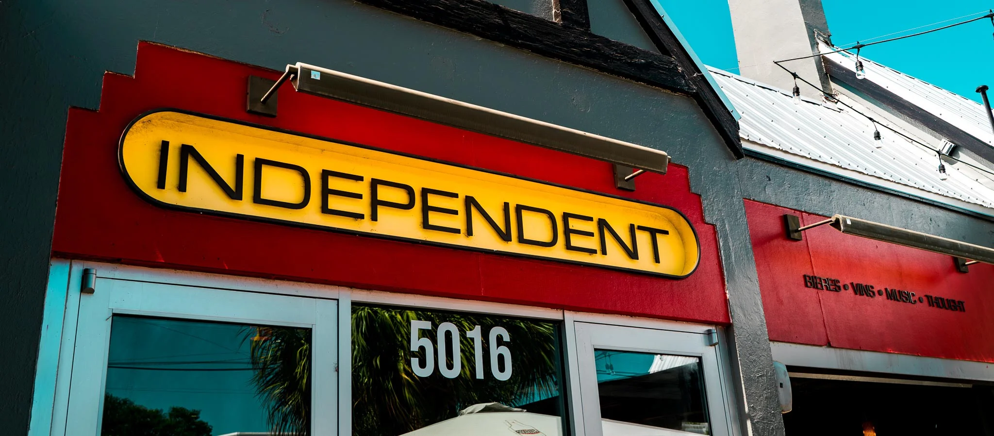 Exterior view of a restaurant named 'Independent' with vibrant signage.