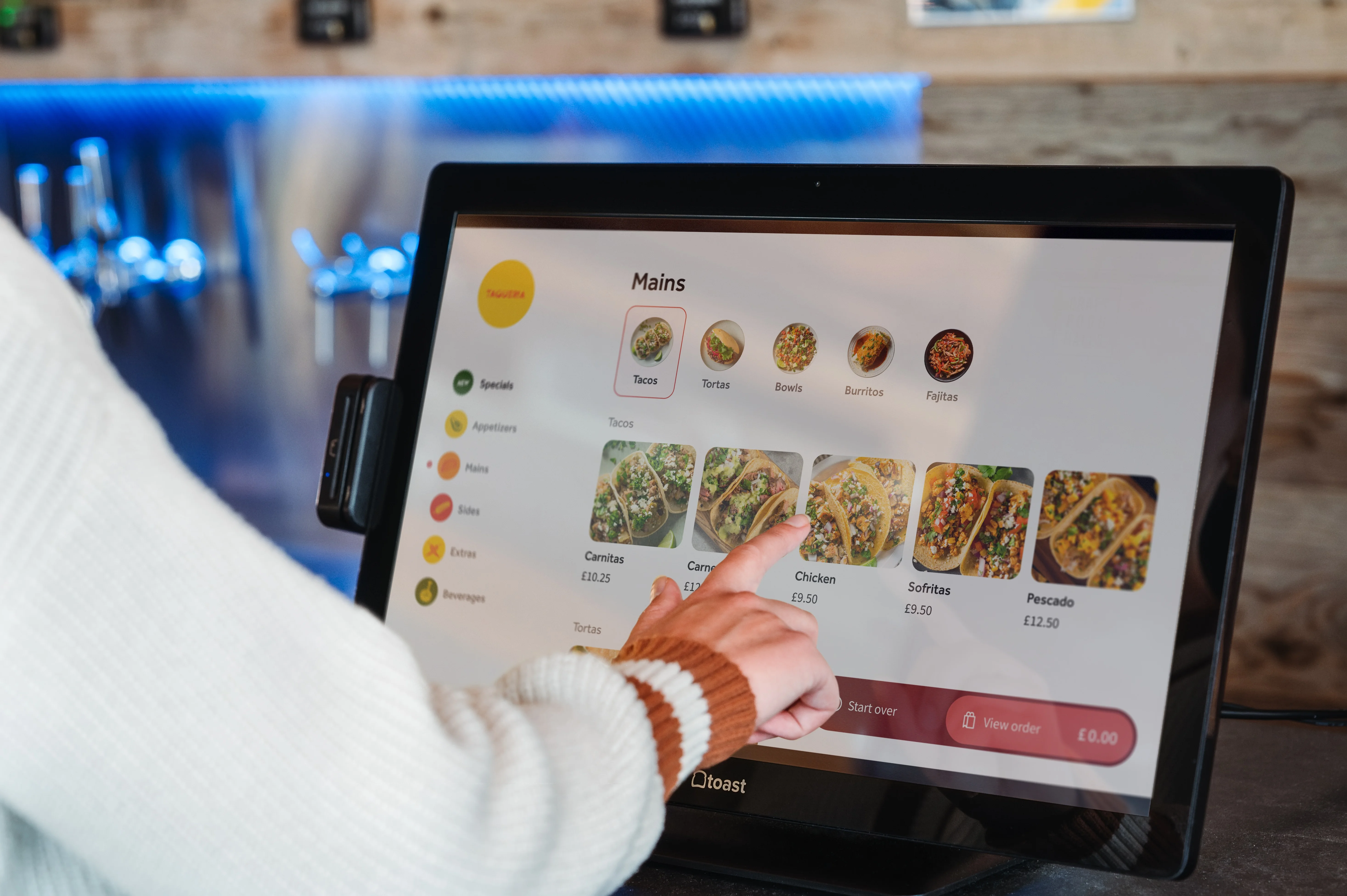 A Toast Kiosk showing tacos being ordered
