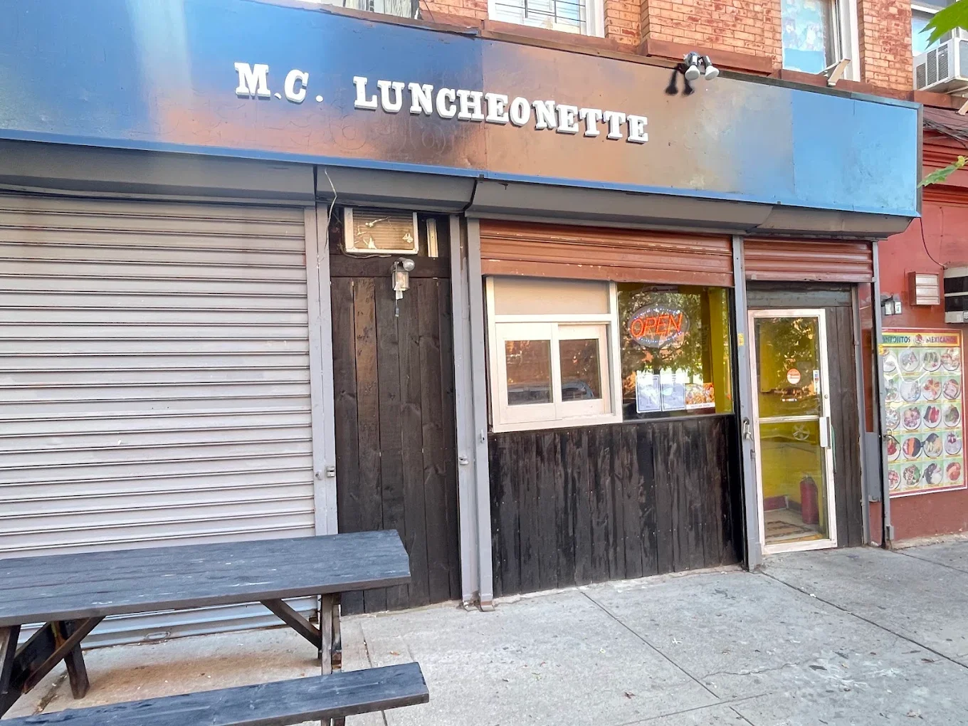 Exterior view of M.C. Luncheonette restaurant with open sign