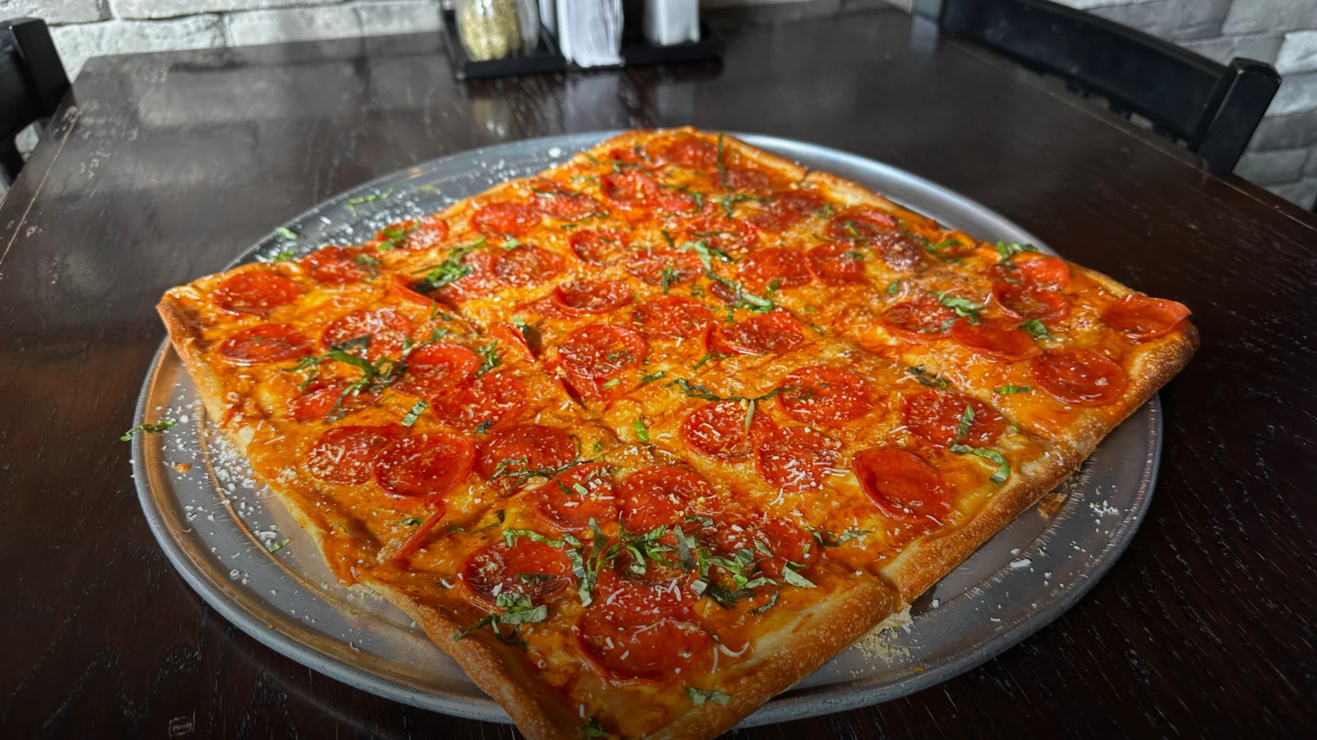 Thin crust Sicilian pizza with vodka sauce, pepperoni, parmesan cheese, basil, and Mike's honey hot drizzle