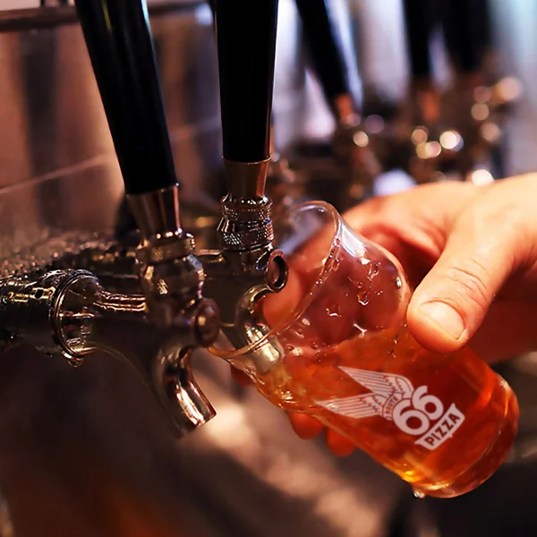 Pouring craft beer from a tap at a bar
