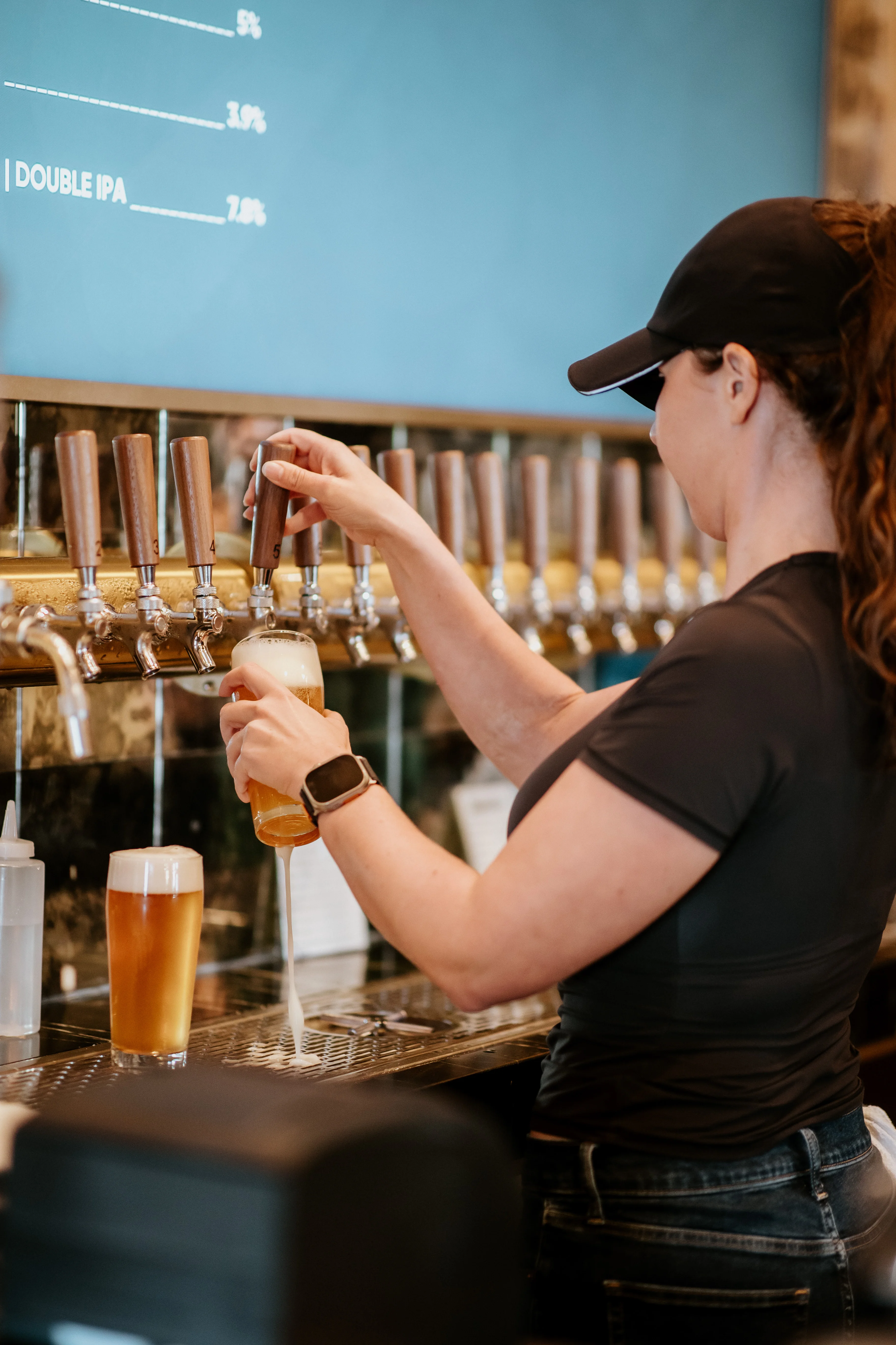Bartender pouring craft beer at a modern bar