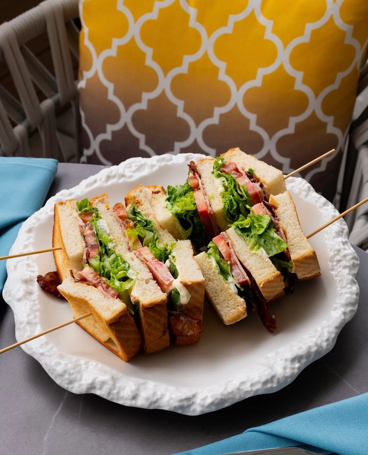 Classic club sandwich with layers of bacon and fresh vegetables