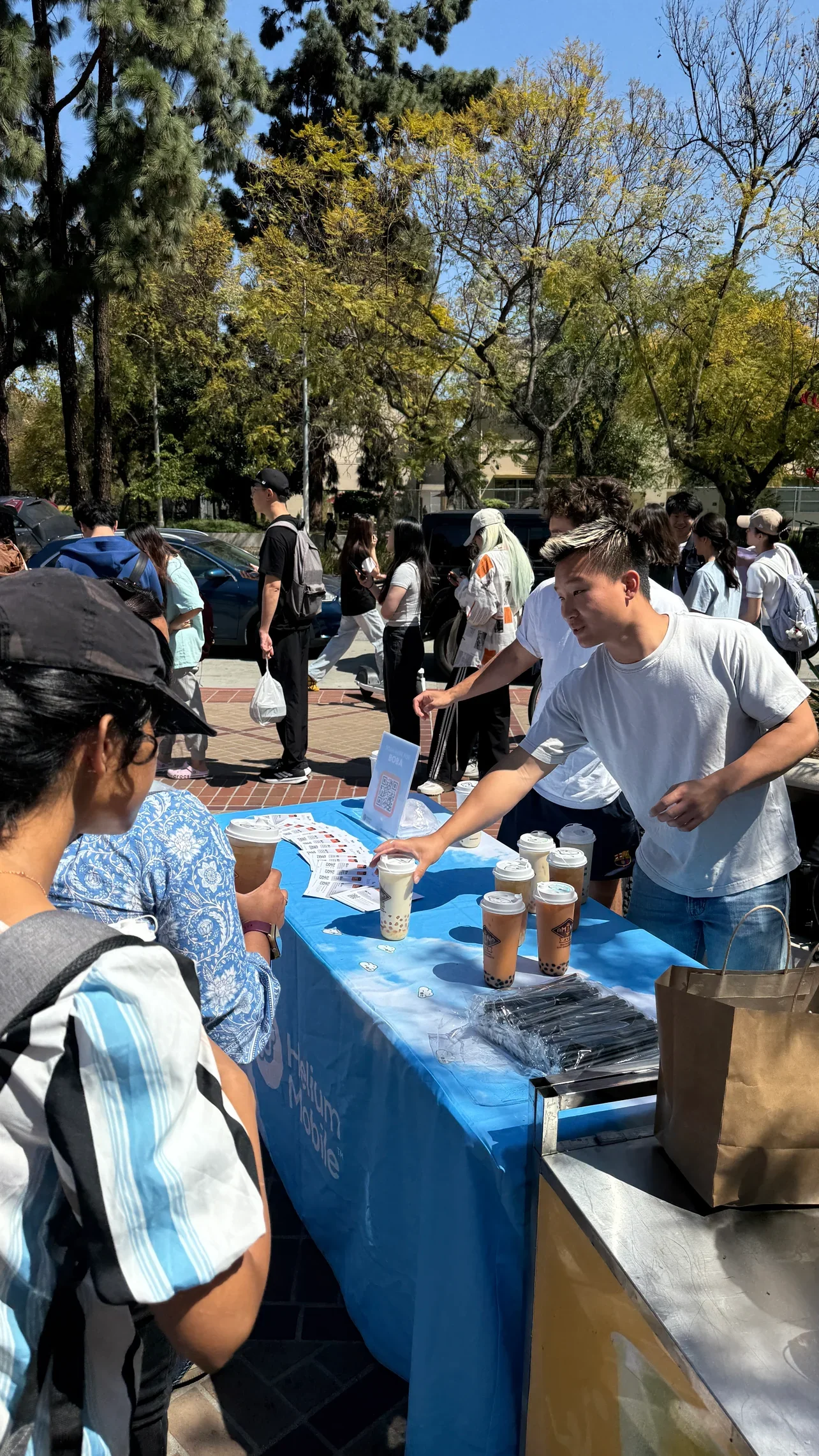 Crowd enjoying bubble tea at an outdoor event