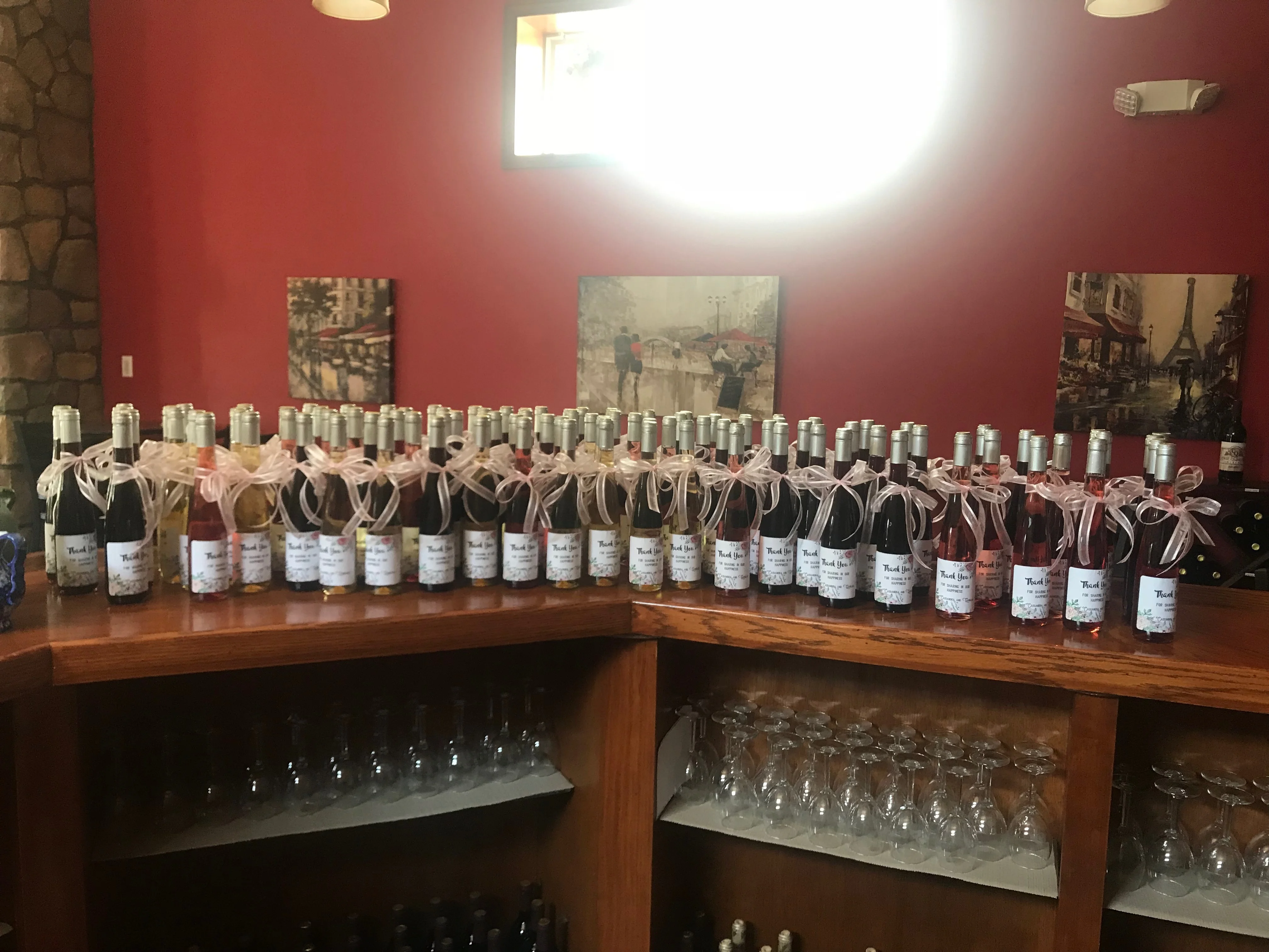 Display of assorted wine bottles with decorative ribbons