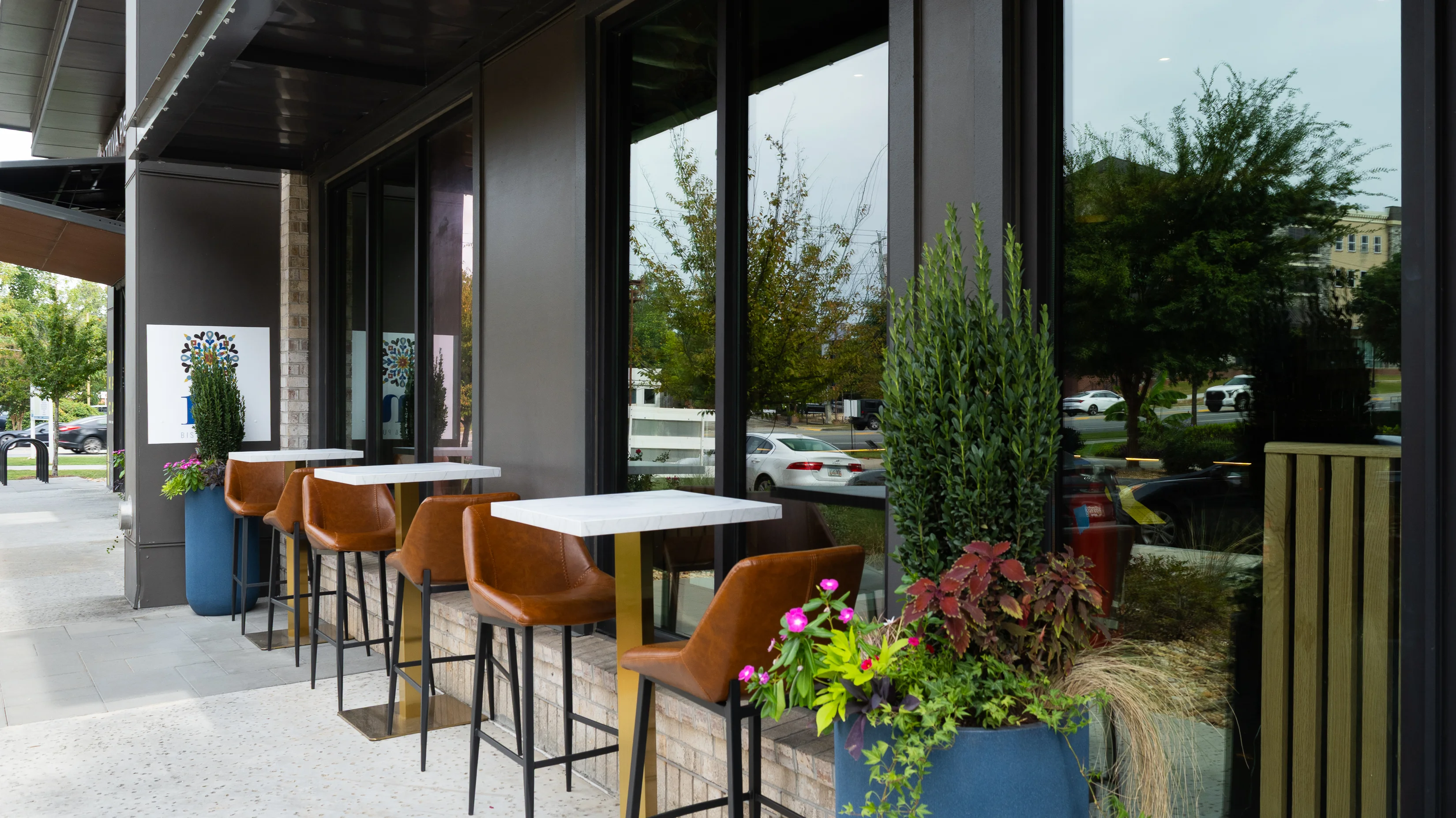 Modern restaurant patio with stylish seating and greenery