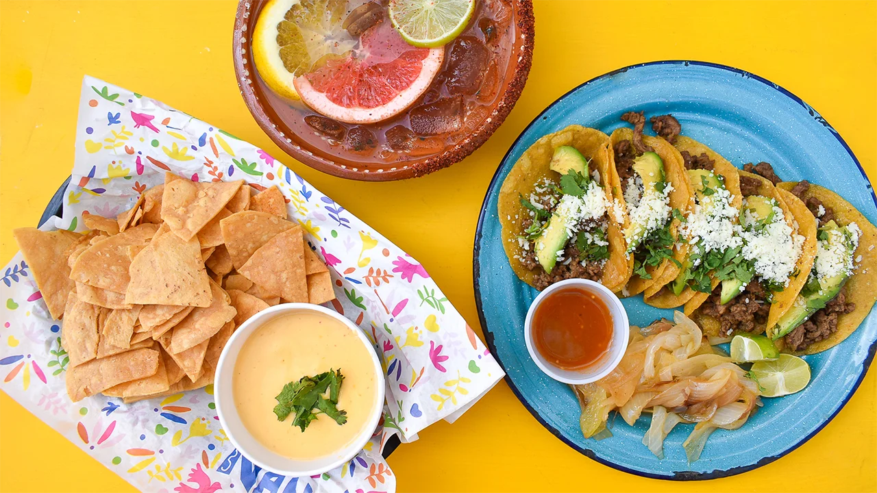 Colorful Mexican tacos with chips and cheese dip