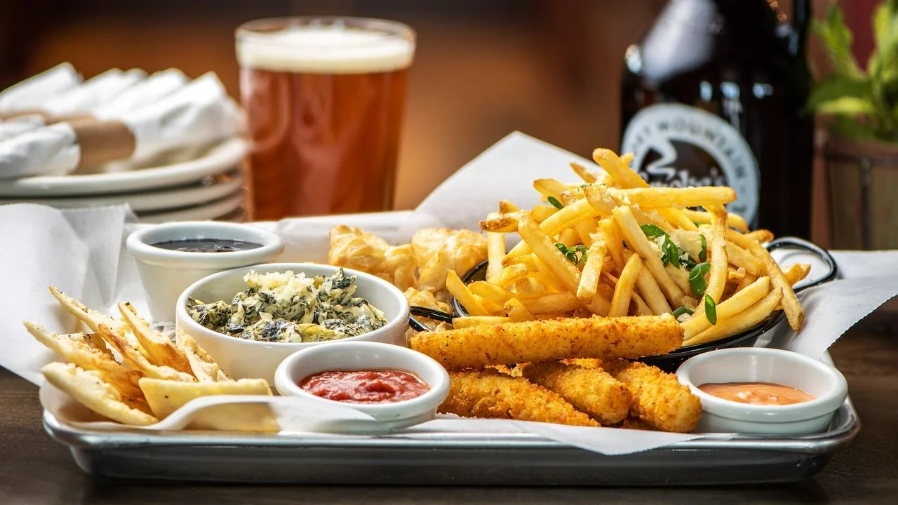 Our appetizer, The Motherlode: mozzarella sticks, spinach dip, french fries,  & Smoky's famous Brie Kisses®