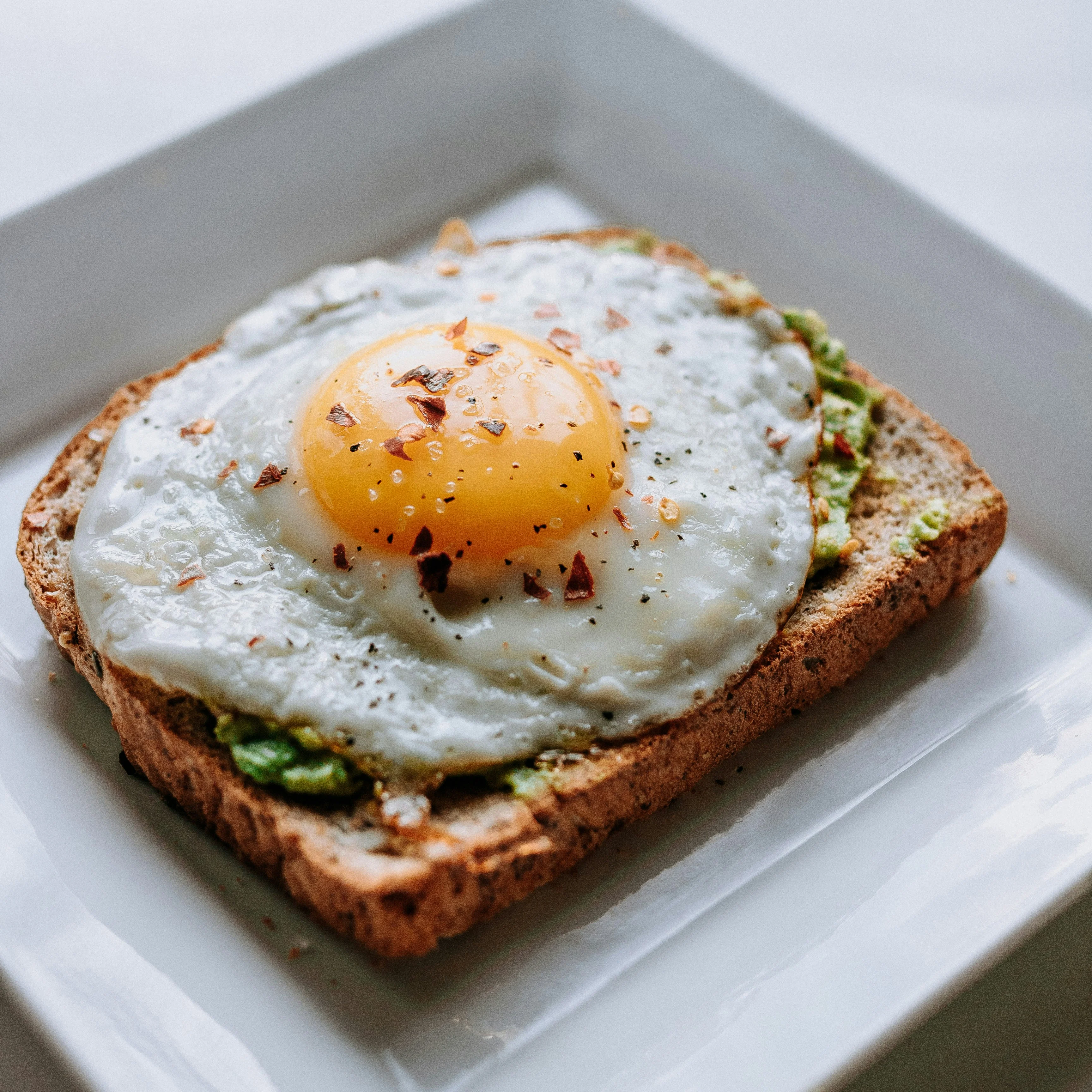 Avocado toast topped with a fried egg