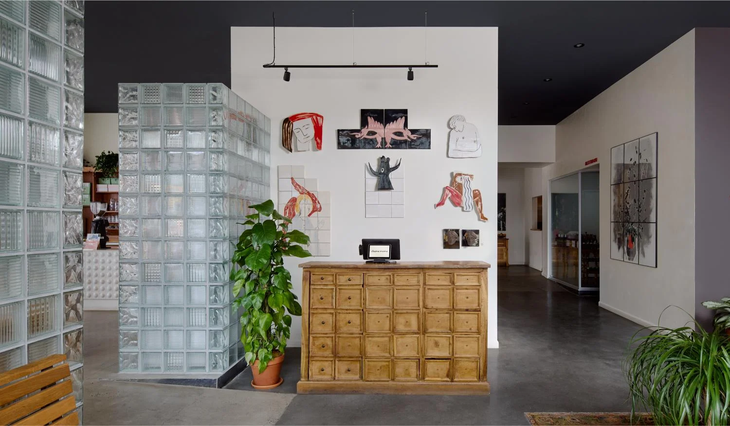 Stylish restaurant interior with artistic decor and wooden reception desk