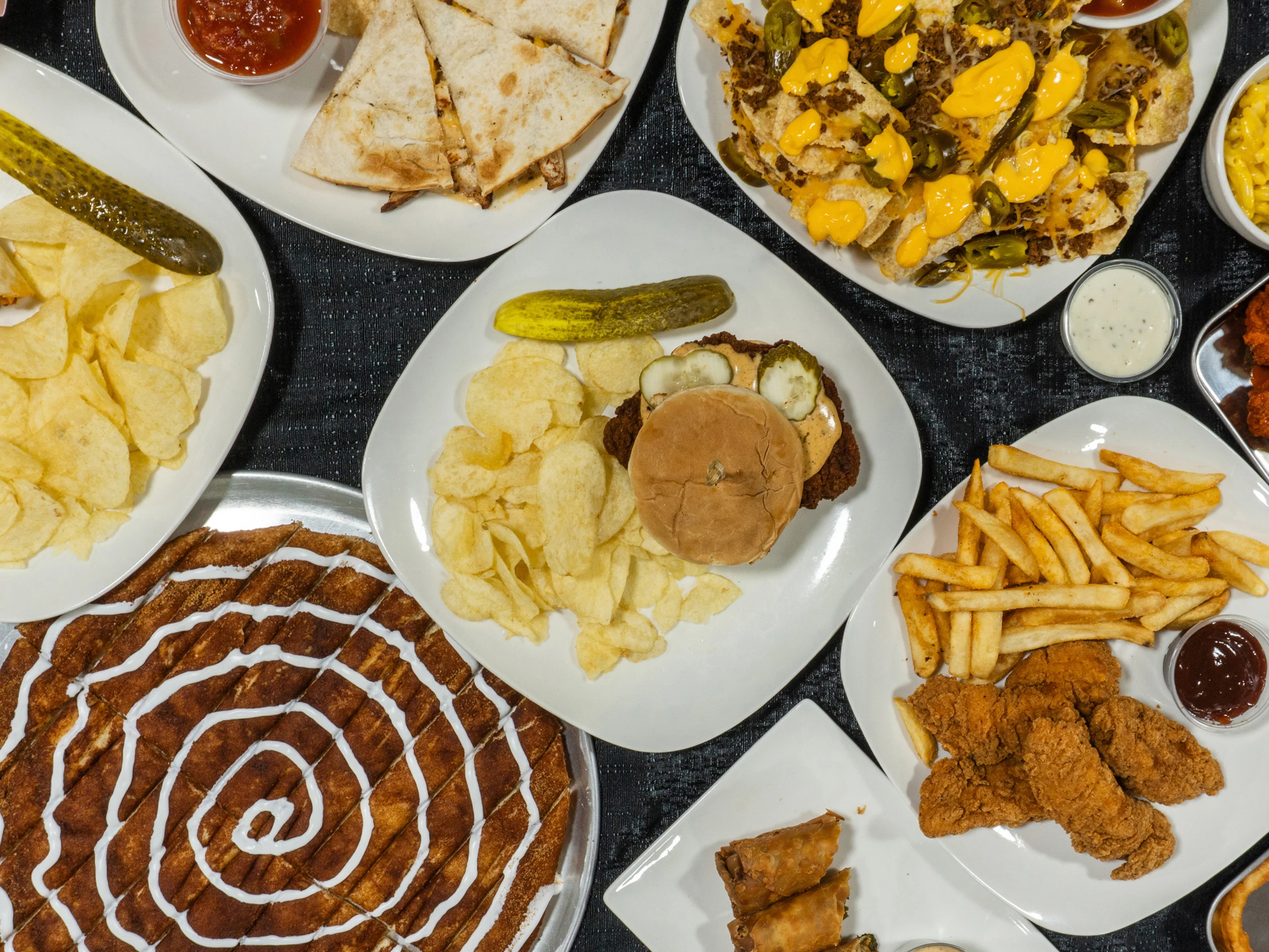 Assorted American comfort food platter with fried chicken and nachos