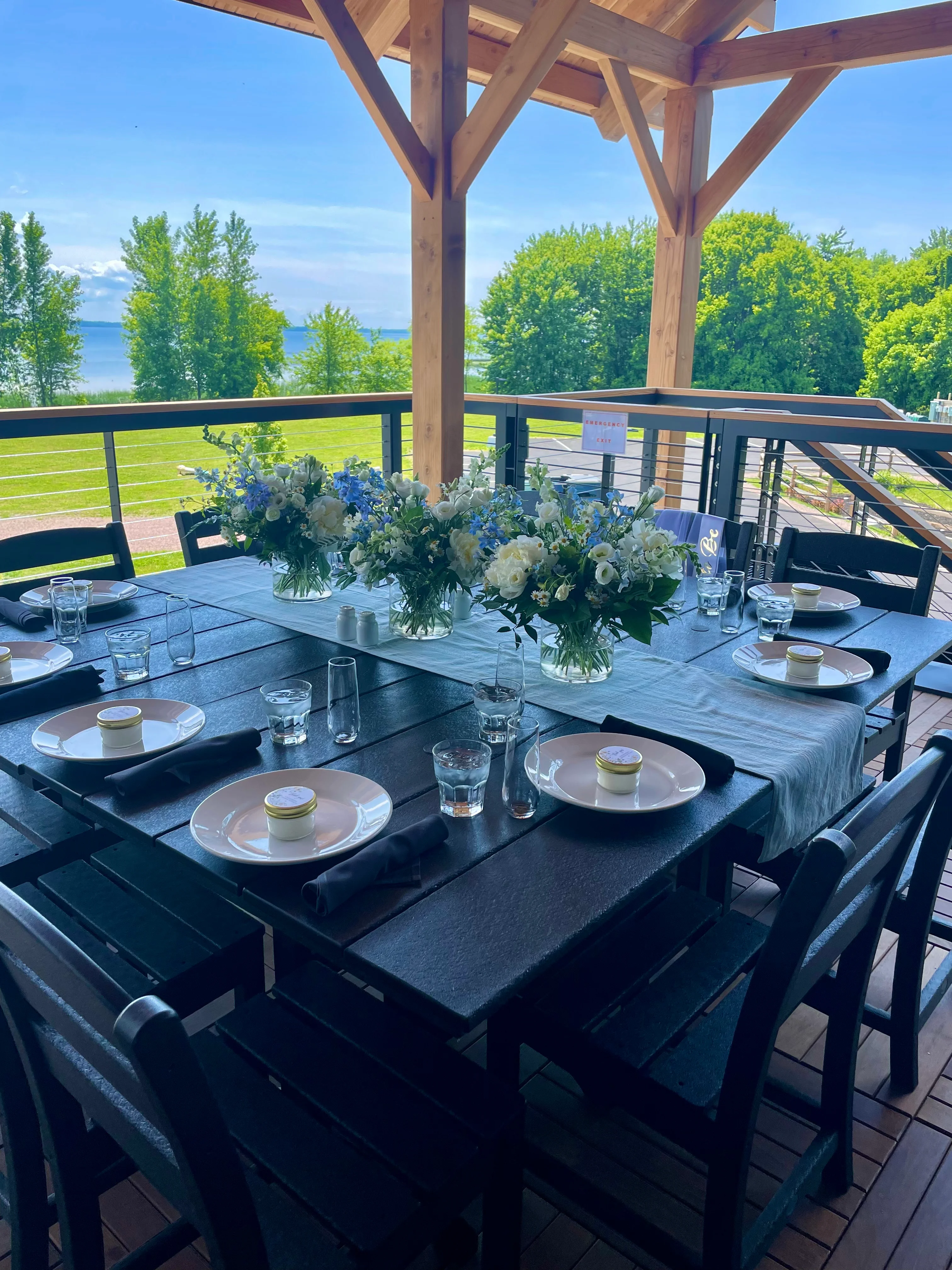 Elegant outdoor dining setup with floral centerpiece and scenic view