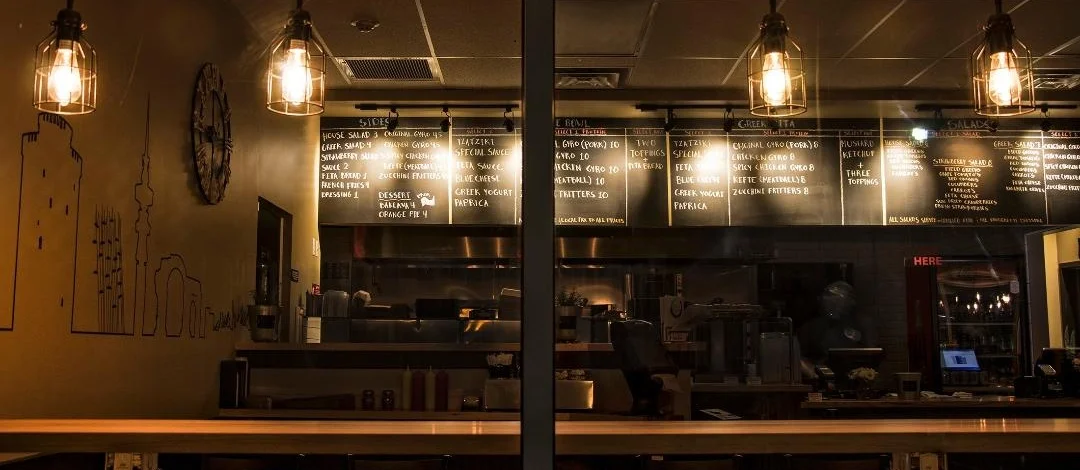 Cozy restaurant interior with illuminated menu and warm lighting