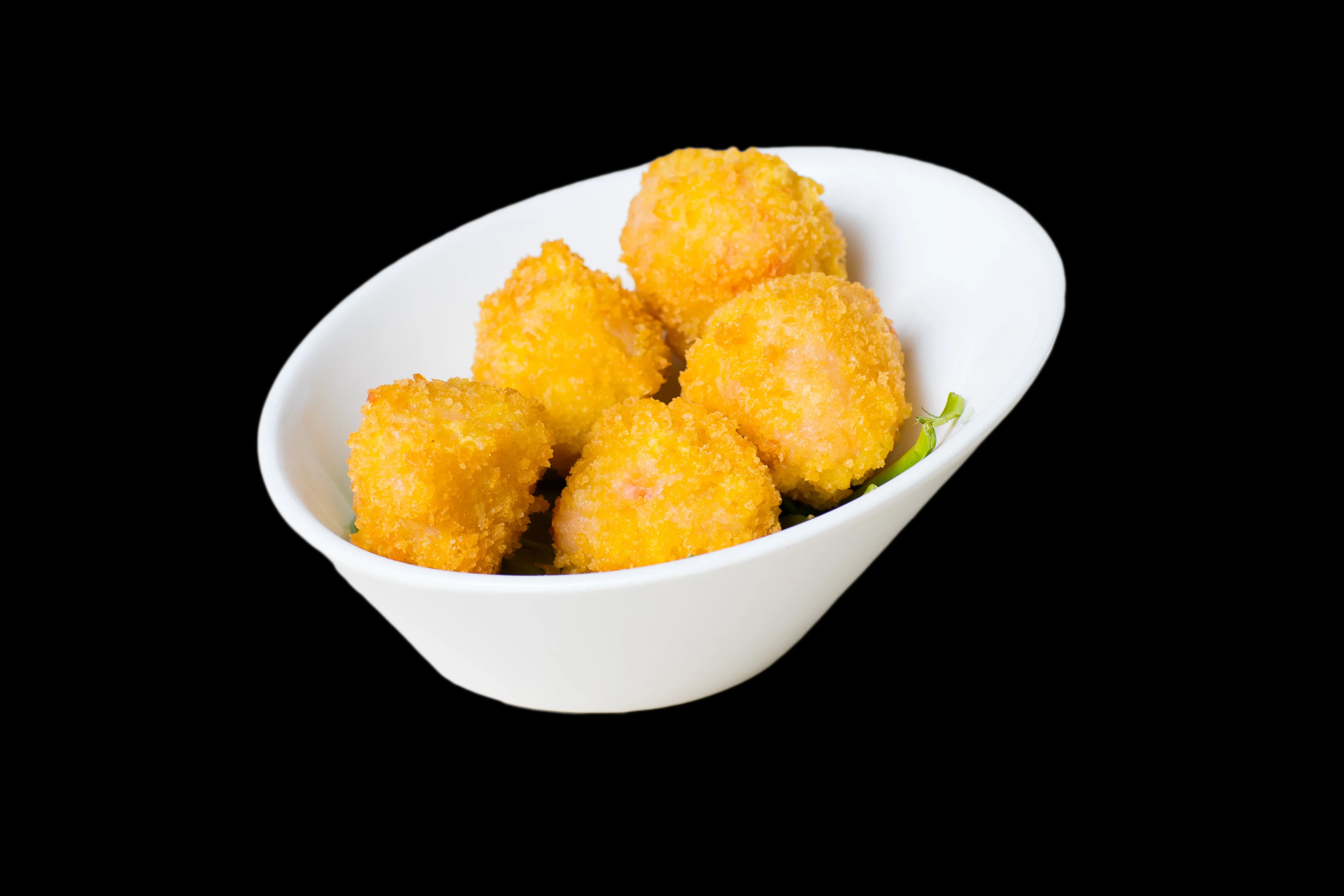 Crispy shrimp balls served on a plate with garnishes.