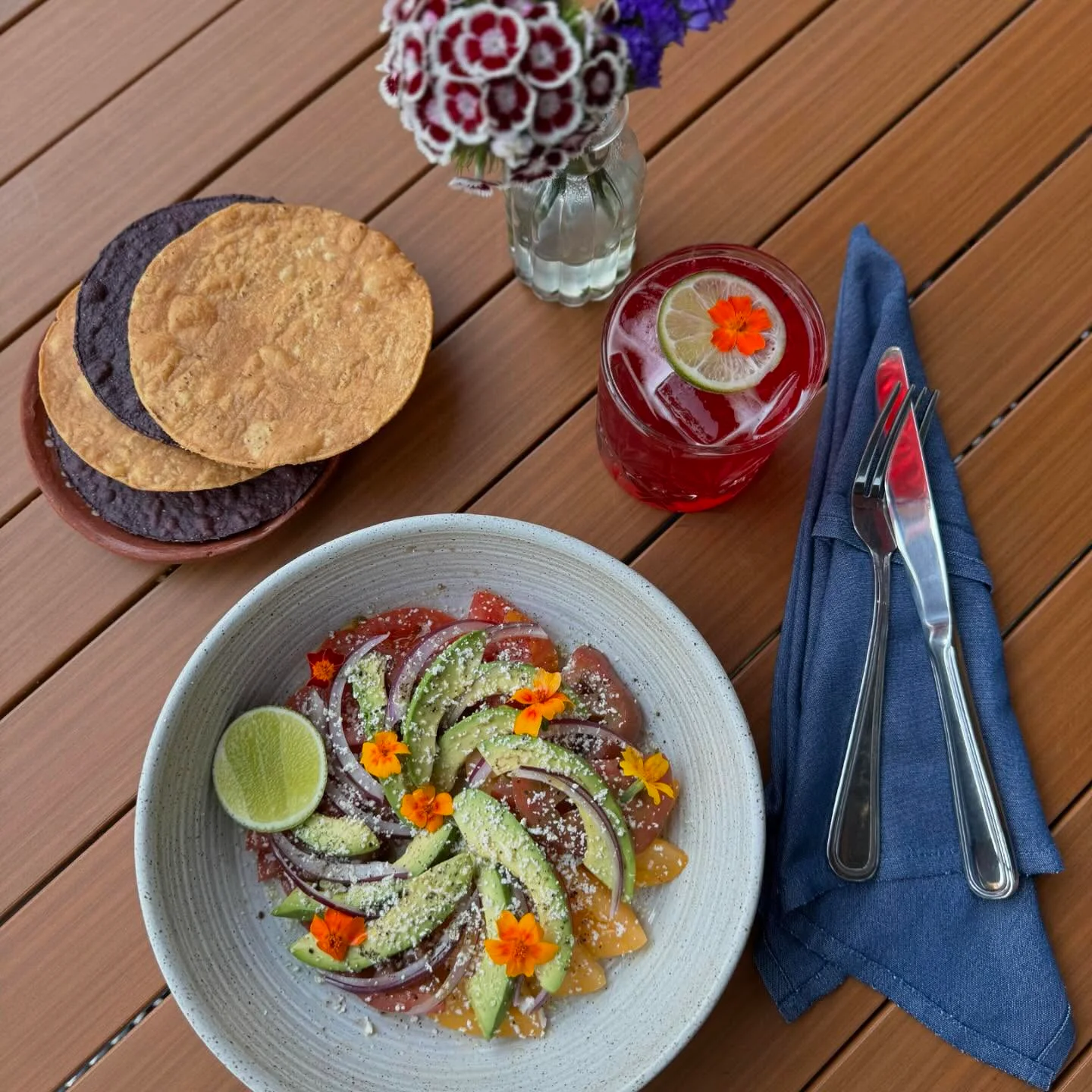 Colorful Mexican ceviche with avocado and edible flowers