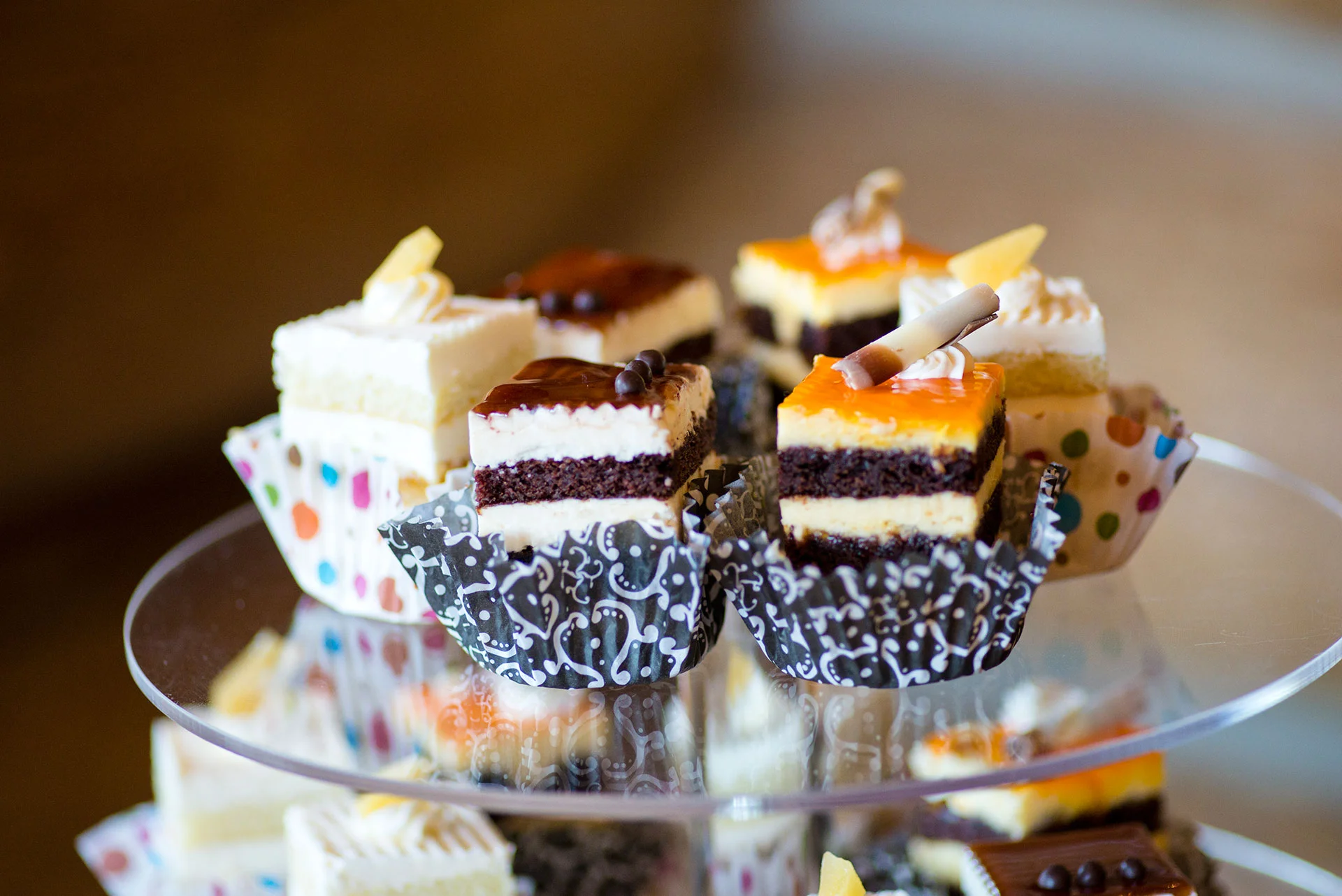 Assorted mini cakes on a tiered dessert stand